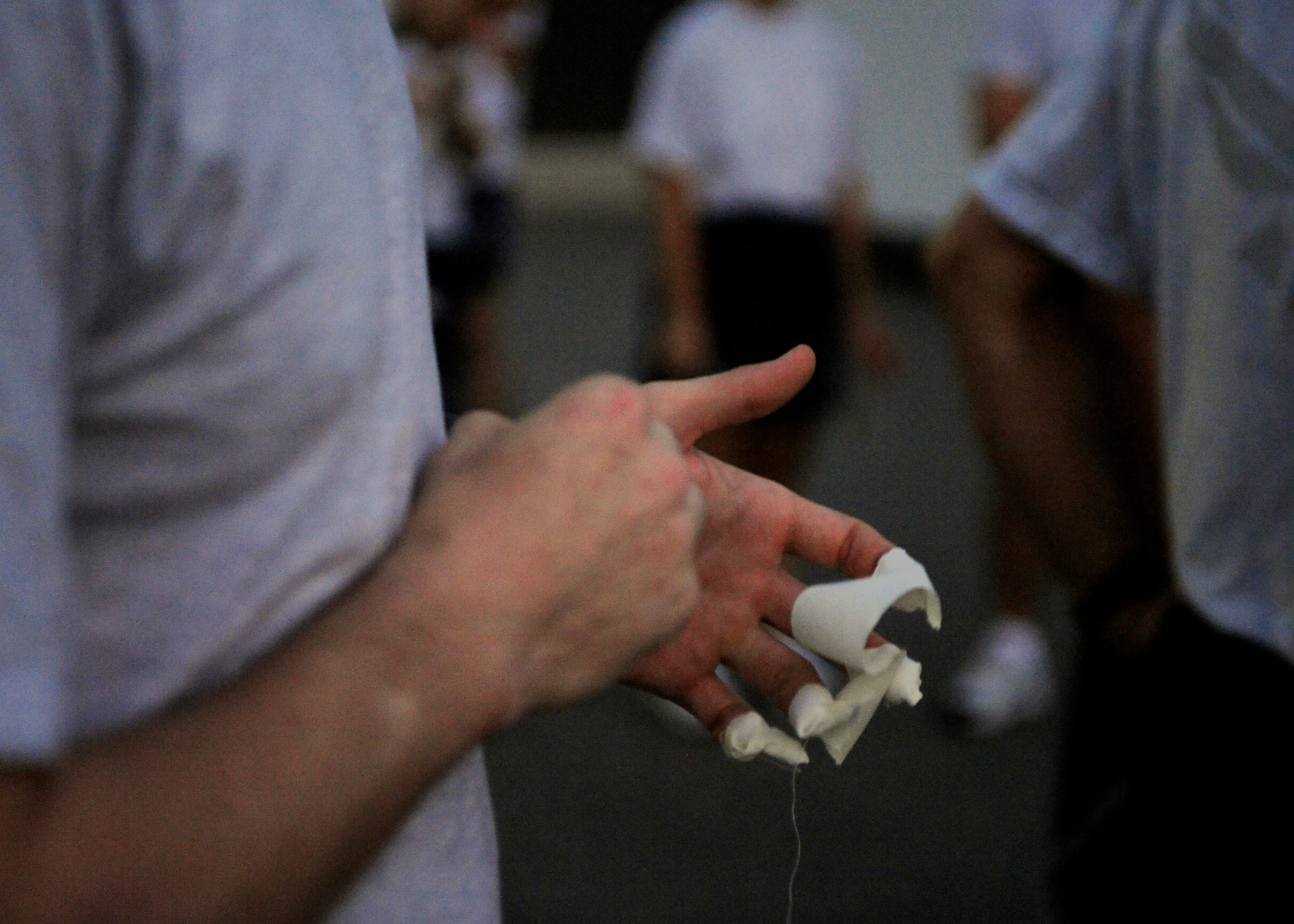 MOODY AIR FORCE BASE, Ga. – An 820th Security Forces Group Airman tapes his fingers before participating in a CrossFit exercise during the Airman 1st Class Leebernard Chavis Memorial Workout Oct. 14 here. Master Sgt. Jason France, 820th SFG CrossFit instructor, developed a new exercise in-remembrance of Airman Chavis. (U.S. Air Force photo by Senior Airman Brittany Barker)