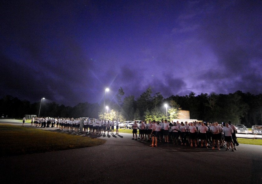 MOODY AIR FORCE BASE, Ga. -- Members of the 820th Security Forces Group, 93rd Air Ground Operations Wing, 23rd Security Forces Squadron and the current Airmen Leadership School class fall into a formation before the start of reveille Oct. 14 here. The group later participated in a Airman 1st Class Leebernard Chavis Memorial Workout in remembrance of the two year anniversary of his death in combat. (U.S. Air Force photo by Senior Airman Brittany Barker)