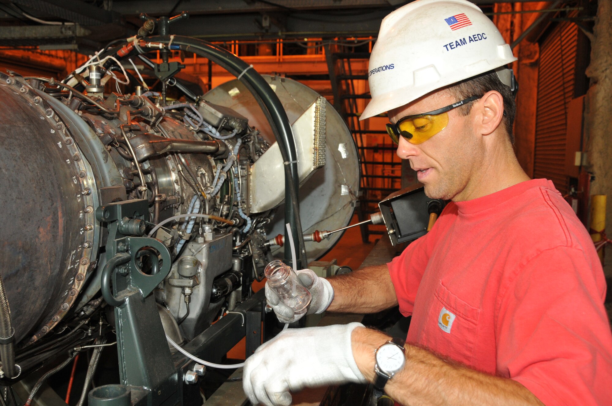 Mike Riddle, a former outside machinist with ATA, takes an oil sample from the J85 engine at UTSI in preparation for a test. Riddle is now a technical specialist with ATA's Testing and Evaluation branch. (Photo provided)