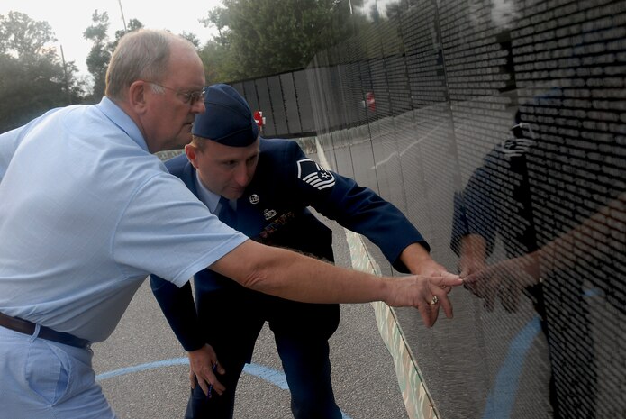 David Lair and Master Sgt. Keith Coyle find the name of a Vietnam War veteran on The Moving Wall displayed at the North Charleston Performing Arts Center in North Charleston, S.C., Oct. 17. Airmen, Sailors, Soldiers, Marines and Coast Guardsmen stood watch 24 hours a day from Oct. 16 to 20 at the wall which is a replica of the Vietnam Veterans National Memorial, The Wall, located in Washington, D.C. Mr. Lair served in the Navy during the Vietnam War and is from Charleston, S.C., and Sergeant Coyle is with the 437th Aircraft Maintenance Squadron. (U.S. Air Force photo/Airman 1st Class Melissa White)