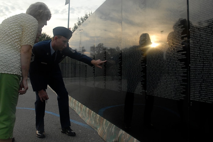 Master Sgt. Keith Coyle shows Marilyn and David Lair the name of a Vietnam War veteran they were looking for on The Moving Wall displayed at the North Charleston Performing Arts Center in North Charleston, S.C., Oct. 17. Airmen, Sailors, Soldiers, Marines and Coast Guardsmen stood watch 24 hours a day from Oct. 16-20 at the wall which is a replica of the Vietnam Veterans National Memorial, The Wall, located in Washington, D.C. Sergeant Coyle is with the 437th Aircraft Maintenance Squadron and the Lairs are from Charleston, S.C. (U.S. Air Force photo/Airman 1st Class Melissa White)