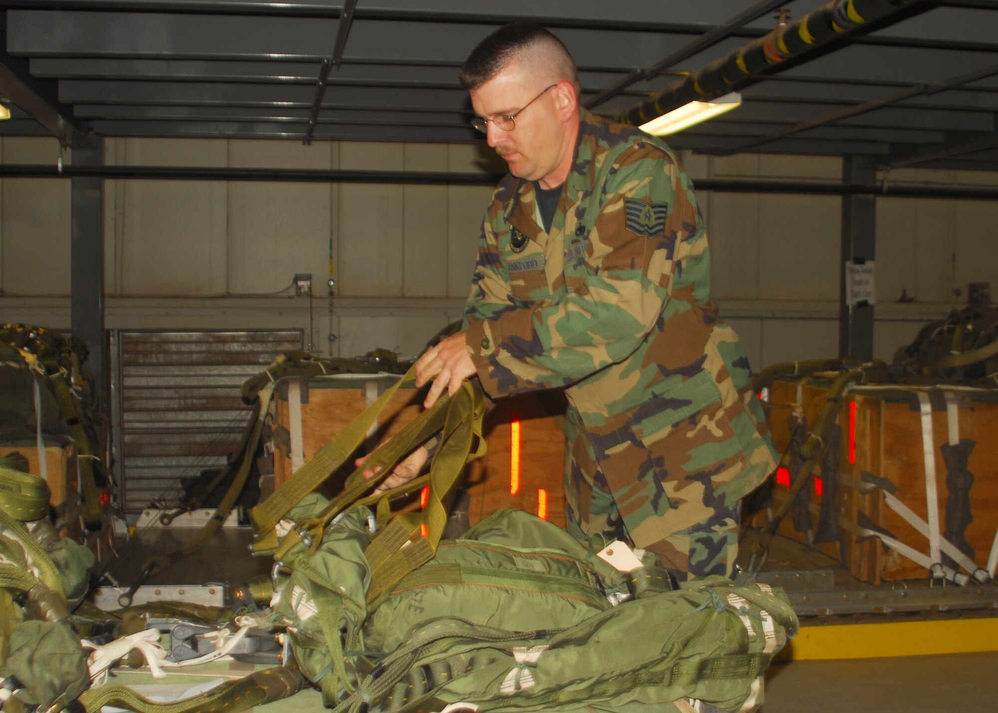 Tech. Sgt.  Joseph Lankford of the 97 LRS Aerial Delivery flight prepares a pallet for an Oct. 10 training drop over the Sooner Drop Zone near Gould, Okla. (U.S. Air Force photo/Senior Airman Amanda M. Bower)