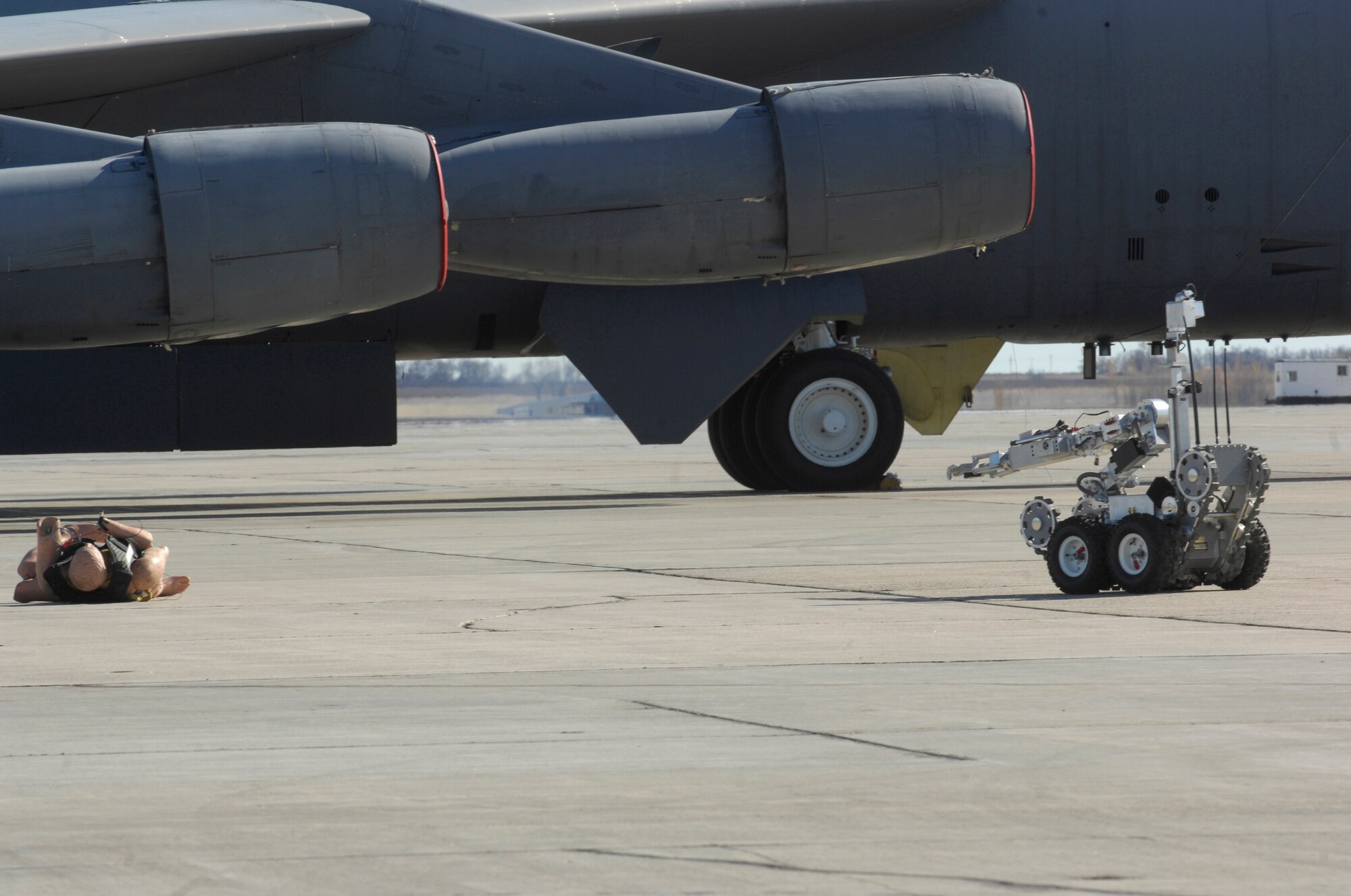MINOT AIR FORCE BASE, N.D. -- An F6A robot, remotely operated by Airmen from the 5th Civil Engineer Squadron explosive ordnance disposal flight, moves around a simulated suicide bomber to assess the best avenue of approach during an All Hazards Response Training exercise here Oct. 15. The exercise was designed to test responding agencies’ capabilities during a crisis scenario. (U.S. Air Force photo by Senior Airman Joe Rivera)