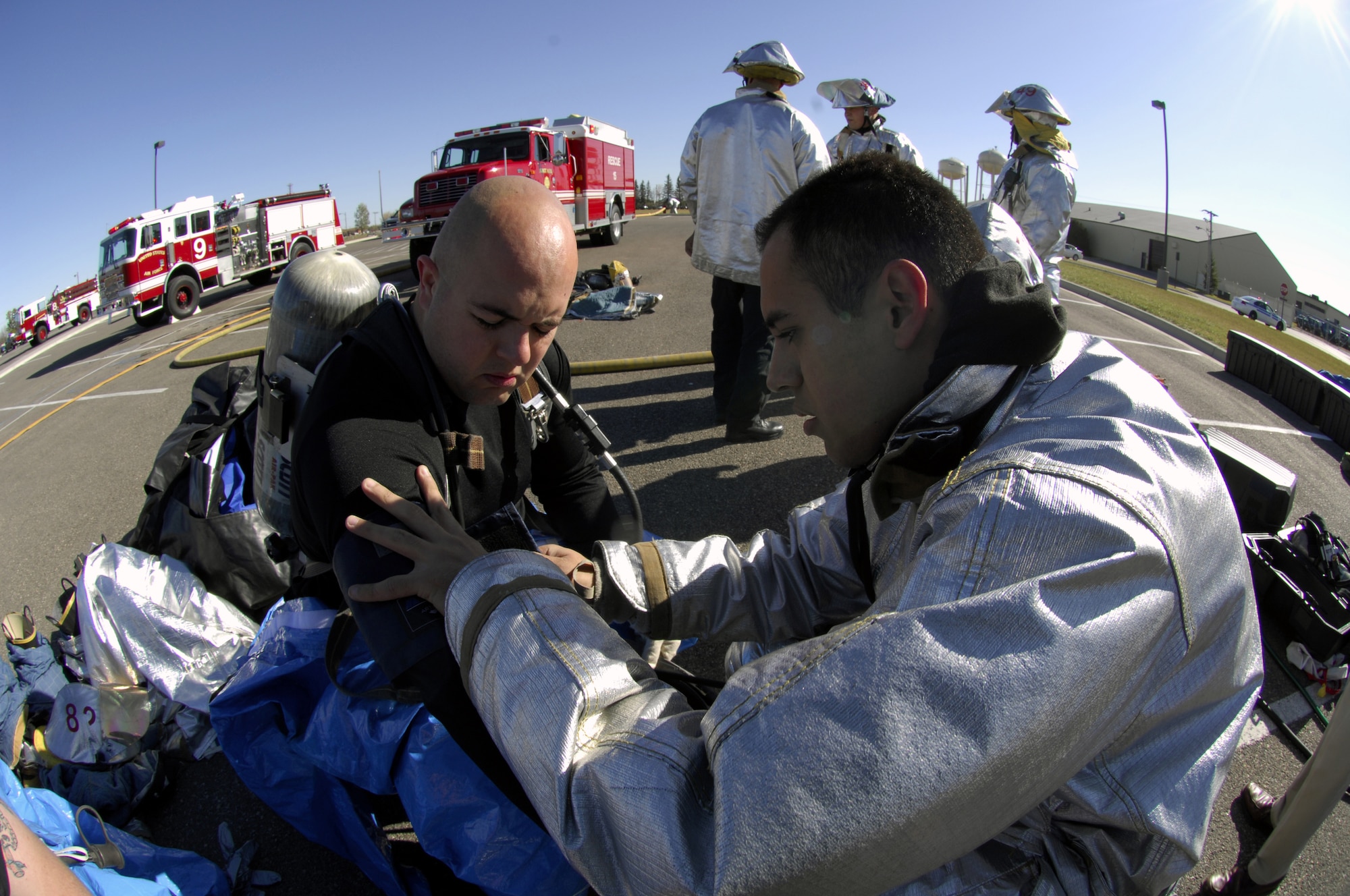 MINOT AIR FORCE BASE, N.D. -- Senior Airman Manuel Velez, 5th Civil Engineer Squadron firefighter, has his vitals examined by Senior Airman David Lucero, also a 5th CES firefighter, before entering the exercise area following a simulated chemical attack on the gym during the All-Hazards Response Training exercise here Oct. 15. The exercise was designed to test responding agencies’ capabilities during a crisis scenario. (U.S. Air Force photo by Airman 1st Class Jesse Lopez)