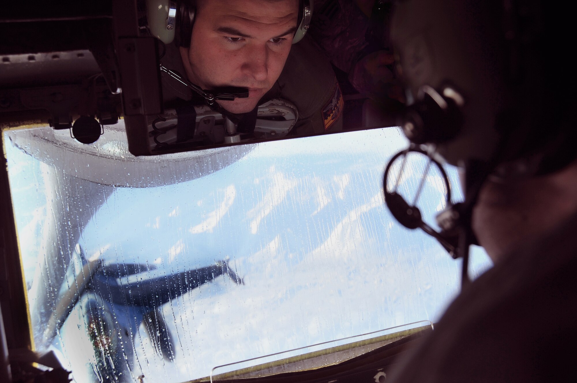 Senior Airman Parker McElroy, 384th Air Refueling Squadron, McConnell Air Force Base, refuels an F-16 Fighting Falcon Oct. 16, during a mission. Airman McElroy is here at Eielson Air Force Base for Red Flag ? Alaska where he and others develop combat readiness through various training missions to provide refueling support to fighters that simulate attacking and defending against enemies. For this mission, Airman McElroy is the boom operator controlling the flow of the much needed fuel to the fighters. (U.S. Air Force photo by Airman 1st Class Willard E. Grande II)