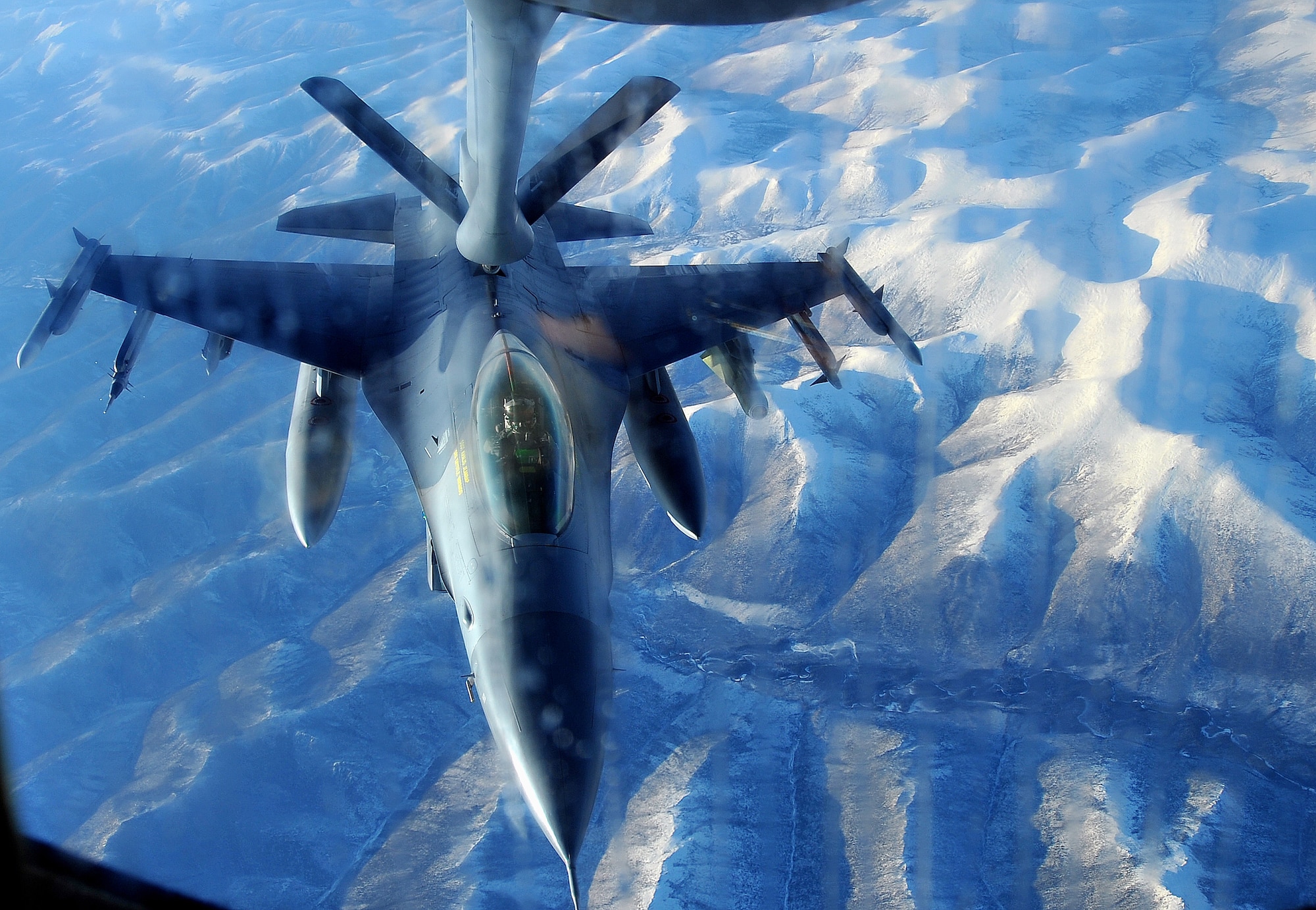 An 8th Fighter Wing F-16 Fighting Falcon from Kunsan Air Base Korea waits to finish refueling before continuing his mission Oct. 16. The Wolf Pack, as the 8th Fighters are known, is on TDY to Eielson Air Force Base for Red Flag ? Alaska where they develop combat readiness through various training missions to attack and defend against simulated enemies. (U.S. Air Force photo by Airman 1st Class Willard E. Grande II)
