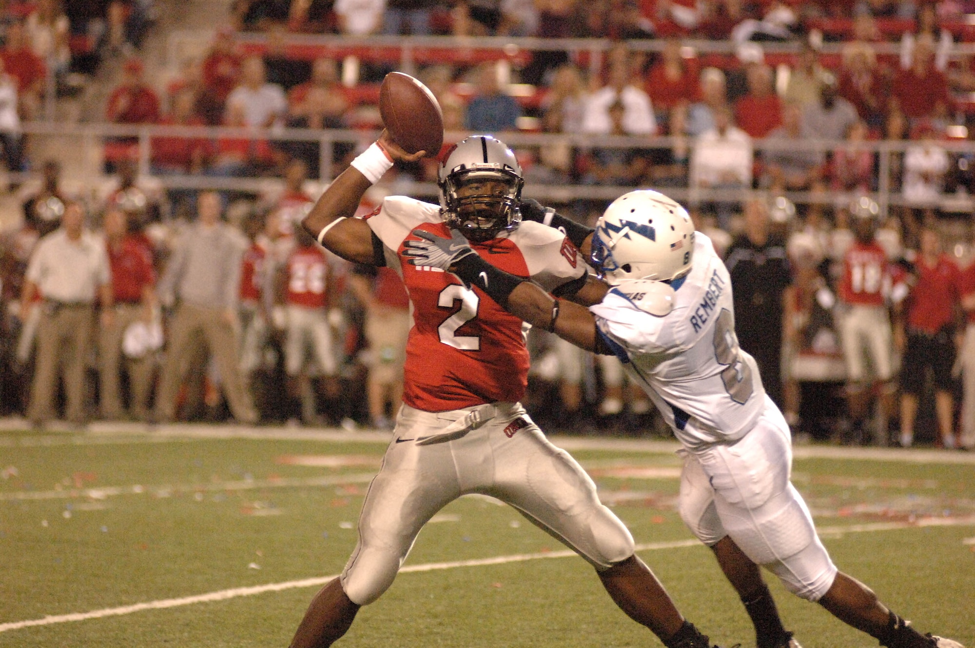 U.S. Air Force Academy cornerback Reggie Rembert works to disrupt the passing of University of Nevada, Las Vegas quarterback Omar Clayton during a corner blitz Oct. 18 in Las Vegas.The Falcons won 29-28 and improved to 5-2 on the season and 3-1 in the Mountain West Conference. (U.S. Air Force photo/John Van Winkle)