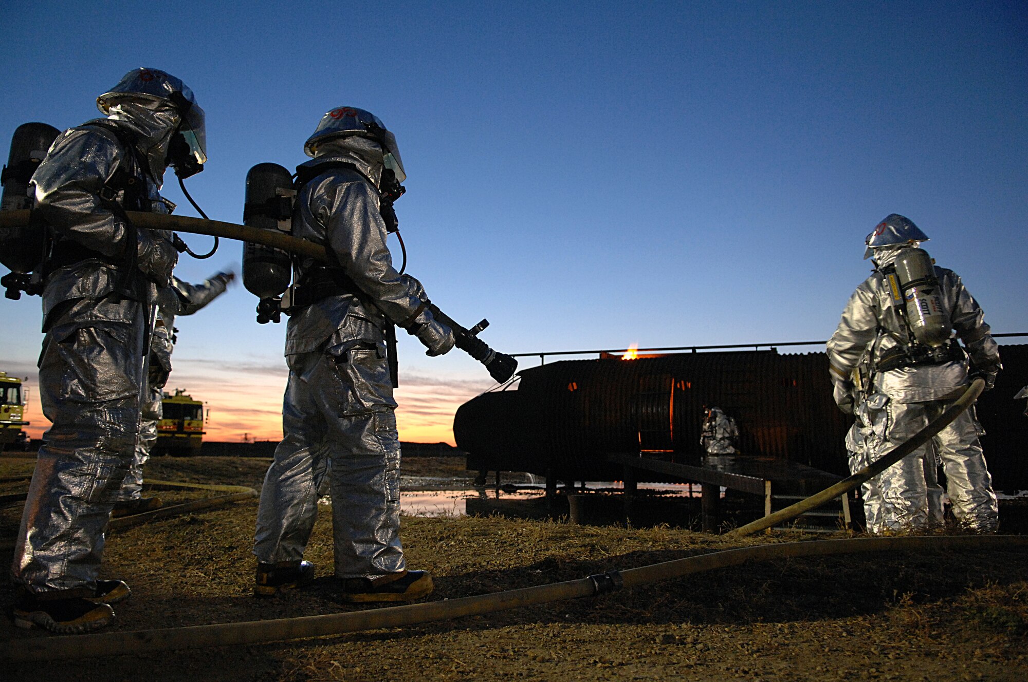MINOT AIR FORCE BASE, N.D. – Firefighters from the 5th Civil Engineer Squadron wait for the signal to advance up the ramp of the base’s live-burn trainer during a training session here Oct. 2. Air Force firefighters are mandated by the Federal Aviation Administration to pass bi-annual recertification training on aircraft fires. (U.S. Air Force photo by Senior Airman Kelly Timney)