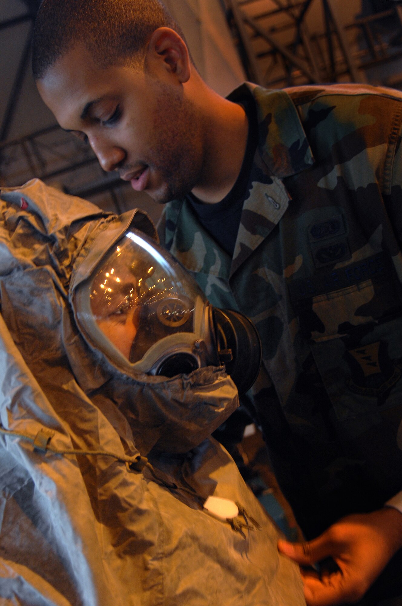Senior Airman Louis Vargus, 435th Civil Engineer Squadron, is used as an example of the proper wear of the gas mask by Senior Airman Lawrence Phelps, Chemical, Biological, Radialogical, and Nuclear Instructor, 835th Civil Engineer Squadron, during a training session at Warrior Preparation Day, Ramstein Air Base, Germany, Oct. 17, 2008. Warrior Prep Day is a training effort to prepare Airmen of all ranks for upcoming deployments by instructing them on the potential threats and effective emergency response actions in a deployed enviroment.(U.S. Air Force photo by Airman 1st Class Tony R. Ritter)(Released)