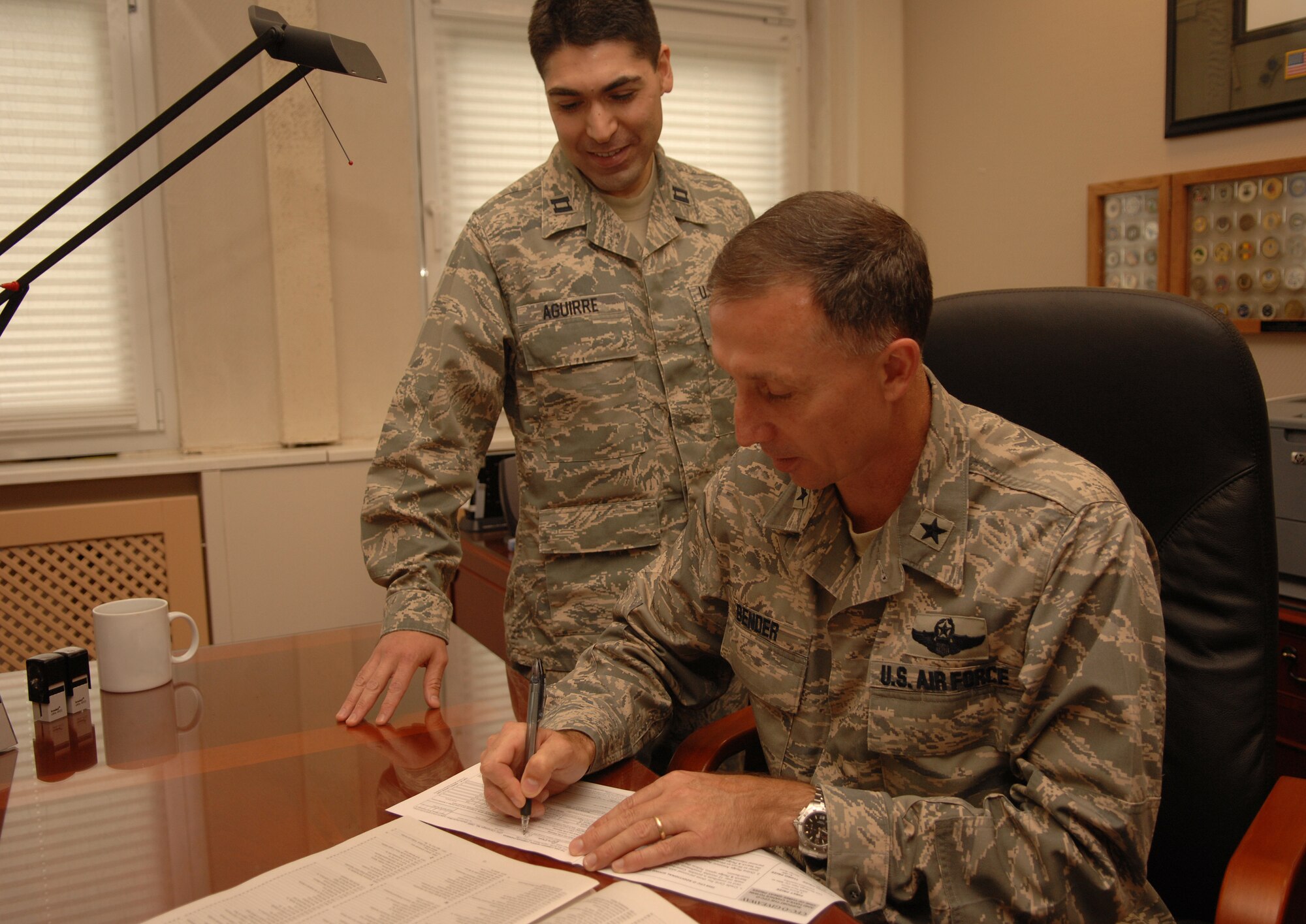 United States Air Force Capt. Rolando Aguirre looks on as Brig. Gen. Bill Bender, KMC and 86th Airlift Wing Commander fills out his Combined Federal Campaign pledge card, Ramstein Air Base, Germany, Oct. 16, 2008. (U.S. Air Force photo by Airman 1st Class Tony R. Ritter) (Released)