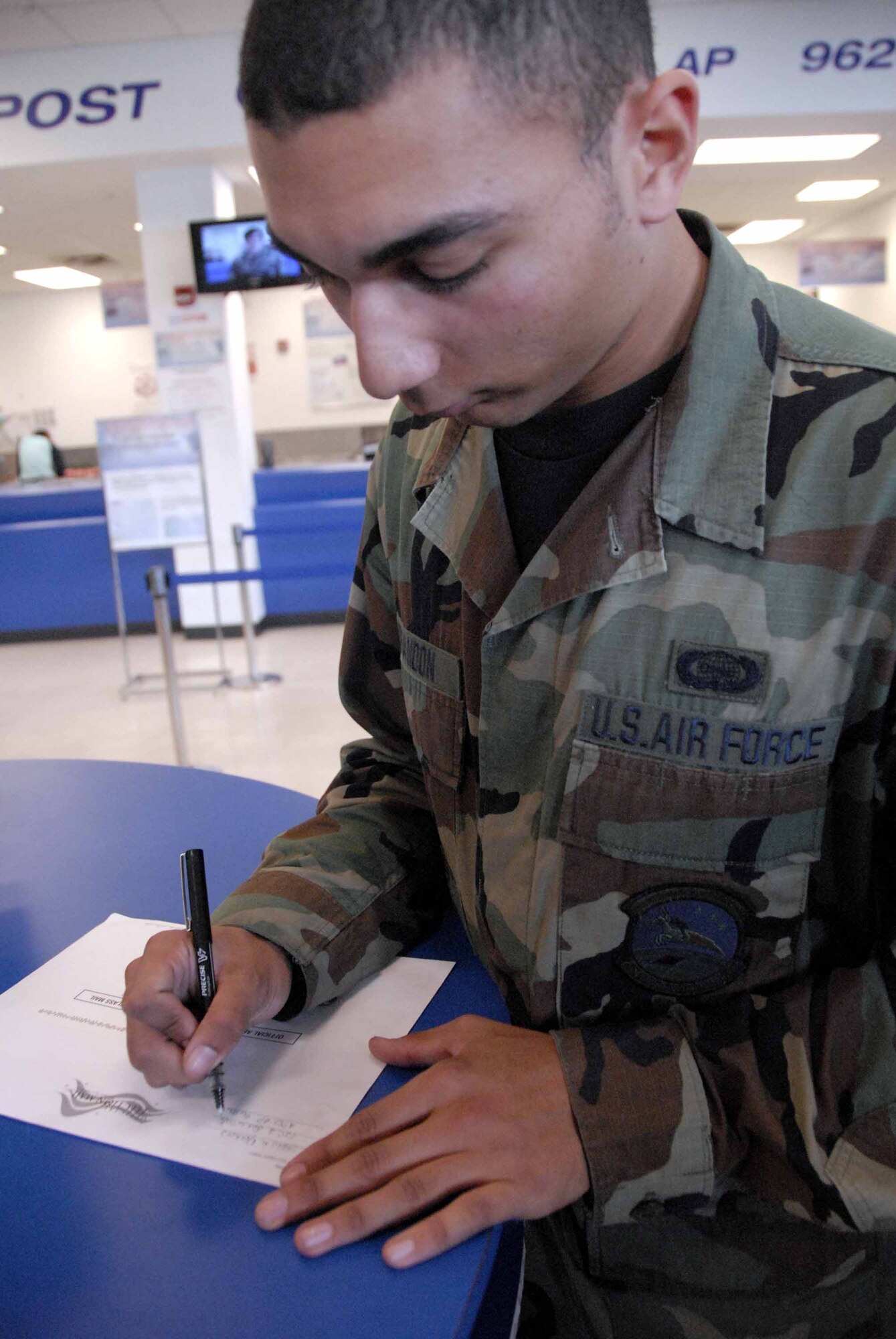 OSAN AIR BASE, Republic of Korea -- Senior Airman Jason Brandon, 51st Communications Squadron ensures the address is correct before mailing his absentee ballot. Beginning Oct. 27, the post office will Express Mail completed ballots directly to the voters’ district, free of charge. (U.S. Air Force photo/Staff Sgt. Candy Knight)