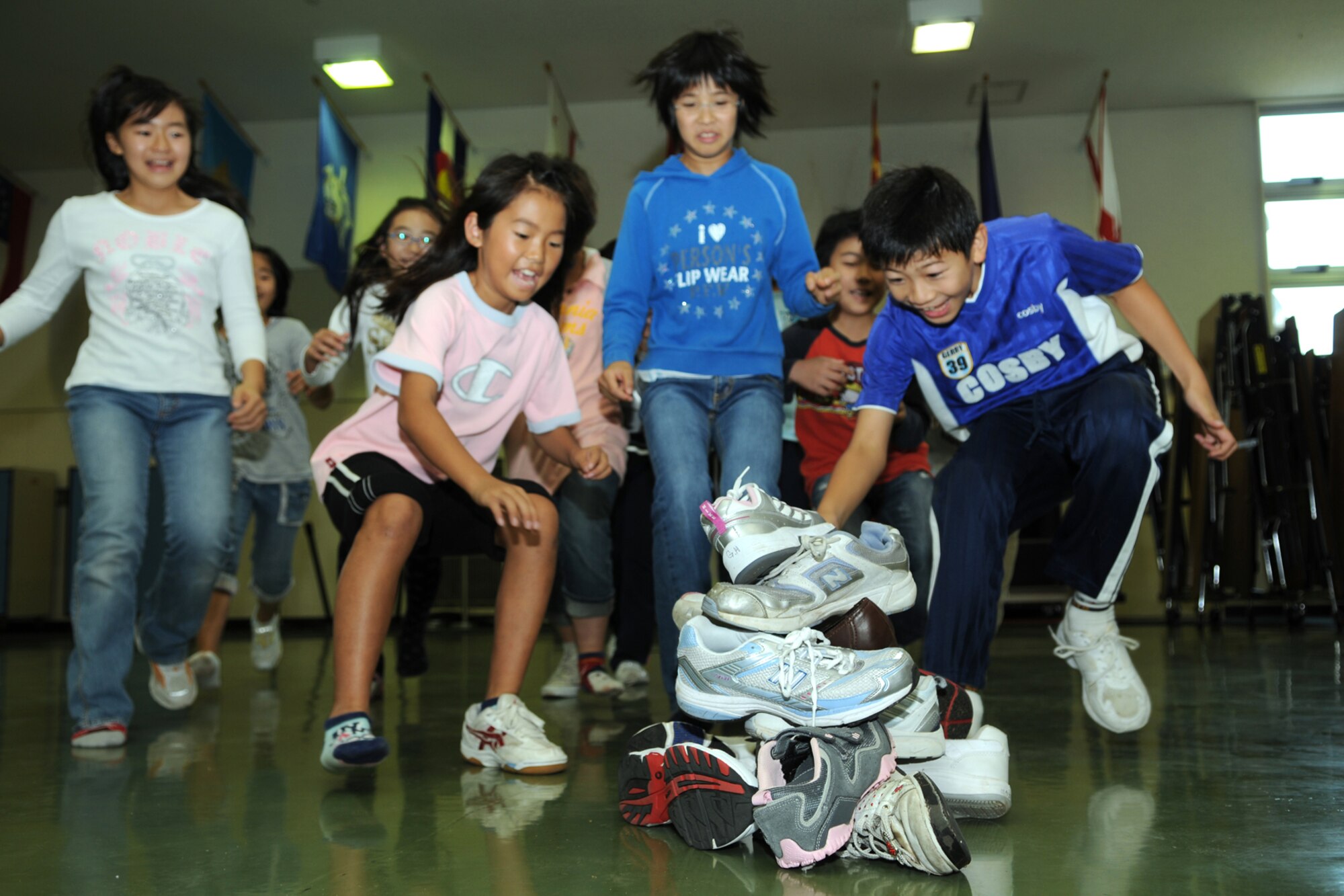 MISAWA AIR BASE, Japan -- Japanese 5th graders go after a pile of shoes during the Children's Cultural Exchange at Sollars Elementary School Oct. 18, 2008. After retrieving a shoe, the children found its American owner, thus, allowing interaction with American children. (U.S. Air Force photo by Airman 1st Class Jamal D. Sutter) 