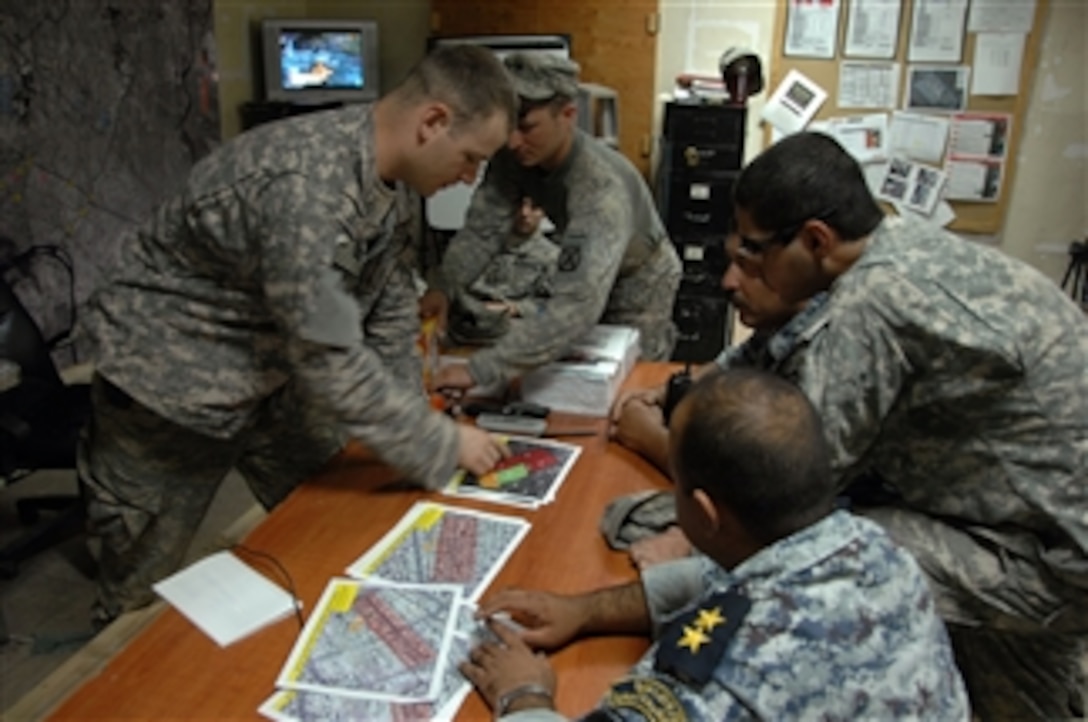 Iraq 3-8-2 National Police leaders are given a mission brief by 2nd Lt. Bobbie Ragsdale (left) of Apache Troop, 3rd Squadron, 89th Cavalry, 4th Brigade Combat Team, 10th Mountain Division prior to the start of phase one of Operation Patriot Enforcement, a cordon and soft knock operation in a neighborhood in Muhallah 902, Wehda, eastern Baghdad, Iraq, on Oct. 9, 2008.  