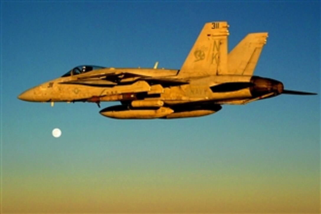 An F/A-18C Hornet assigned to the 'Stingers' of Strike Fighter Squadron 113 embarked aboard the aircraft carrier USS Ronald Reagan flies to an Operation Enduring Freedom mission in Afghanistan, Oct. 15, 2008. The Ronald Reagan and Carrier Air Wing 14 provide support to coalition forces on the ground in Afghanistan.