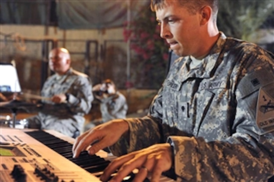 U.S. Army Spc. Thomas Greer plays the keyboard at an outdoor concert to introduce Iraqis to the history of American music in downtown Baquobah, Iraq, Oct. 13, 2008. Greer is assigned to the 1st Armored Division.
