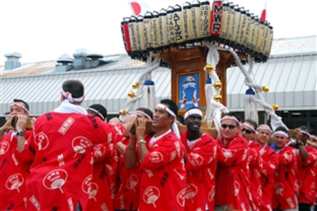 U.S. Navy sailors carry a mikoshi through the streets during the 32nd Yokosuka Mikoshi Parade in Yokosuka, Japan, Oct. 19, 2008. More the 80 sailors volunteered to carry the heavy mikoshi, a portable wooden Shinto shrine, to experience Japanese culture during the festival.