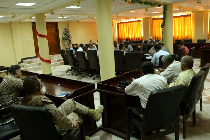 RAMADI, Iraq--Maj. James B. “J.B.” Runyon (bottom left), the executive officer for 2nd Battalion, 9th Marine Regiment, Regimental Combat Team 1, sits in on a meeting between the Ramadi Mayor Latif Obaid Ayadah and the Directors General of Ramadi. The weekly meetings are designed to help the city become a better place for its people to live.