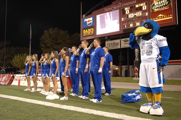 Air Force Falcons cheerleader squad salutes during the national anthem at Sam Boyd stadium Las Vegas, Nev. October 18, 2008.  The Falcons defeated the Rebels 29-28 and improved to 5-2 on the season and 3-1 in the Mountain West Conference.
(U.S. Air Force Photo/Senior Airman Brian Ybarbo)