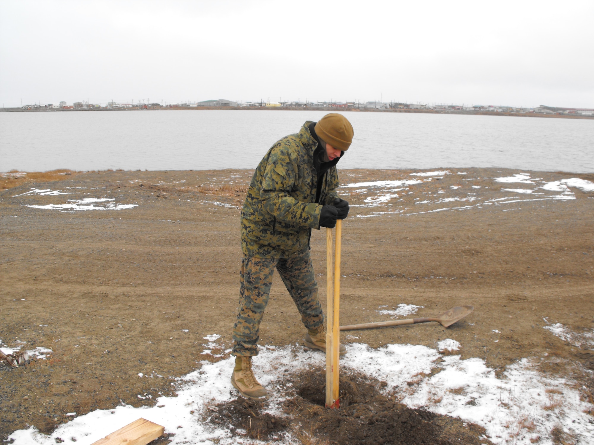 BARROW, Alaska -- Marine Corp Lance Cpl. Jeremy Langford, digs a post hole during the D Company-Antiterrorism Battalion 4th Marine Division's trip here. The members of the company performed several community service projects and held their arctic survival training during the trip. (Courtesy photo)