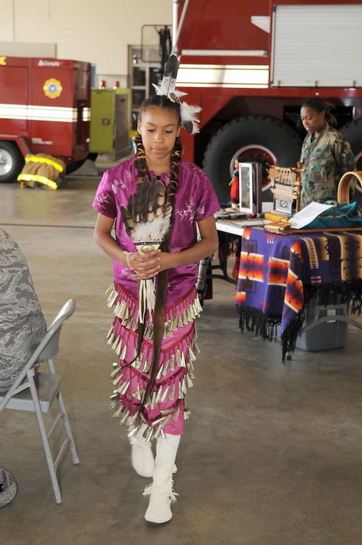 Raven Soto models a ceremonial dress during the Native American Heritage Luncheon held at the Airmen's Firehouse Oct. 16. The Navajo woman’s traditional style of dress usually consists of foot or knee high moccasins and a pleated velvet or cotton skirt. (U.S. Air Force photo/Carlos Cintron)
