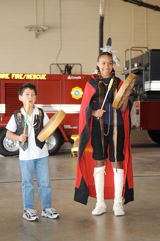Vinnie and Raven Soto play and sing traditional Native American songs for a crowd of Airmen and civilians at the Native American Heritage Luncheon held Oct. 16 at the Airmen's Firehouse. The event also featured traditional Native American food and dances. (U.S. Air Force photo/Carlos Cintron)
