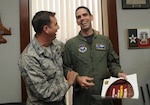 Col. Alan Lake (left), 12th Mission Support Group commander, surprises Lt. Col. Tom Kublie, 19th Air Force Undergraduate Training Branch chief, on Oct. 21 with an all-expense paid trip for two to watch the Arizona Cardinals play the St. Louis Rams on Dec. 7. Colonel Kublie entered the Football Frenzy competition held by the Air Force Services Agency and was selected as the regular season game package winner. The grand prize, which includes an all-expense paid trip for two to Super Bowl XLIII in Tampa Bay, Fla., will be held in early January. Services Club members who attend a Football Frenzy celebration at the enlisted or officers' club can enter by filling out a form, with no purchase neccessary. (U.S. Air Force photo by Rich McFadden)