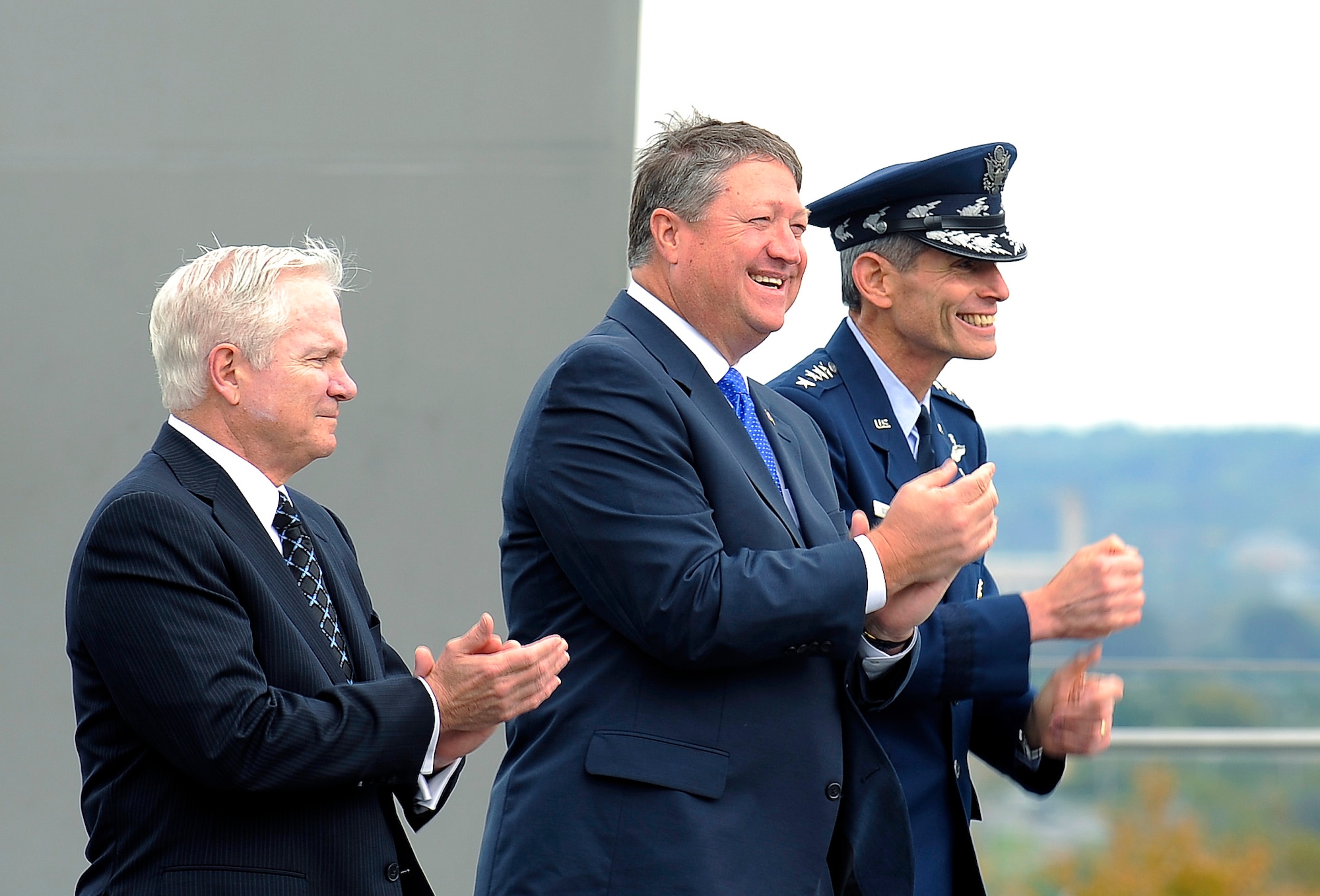 U.S. Defense Secretary Robert M. Gates, Secretary of the Air Force Michael B. Donley and Air Force Chief of Staff Norton A. Schwartz sing the Air Force Song after Secretary Donley's swearing in by Secretary Gates at the Air Force Memorial in Arlington, Va., Oct. 17. (Department of Defense photo/Tech. Sgt. Jerry Morrison)