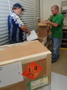 Munitions inspectors Avery Phillips (left) and Jeremy Peterson do inbound check-in maintenance on some boxed items to be stored at the new munitions building on Randolph Air Force Base on Oct. 17. (Air Force photo/Melissa Peterson)