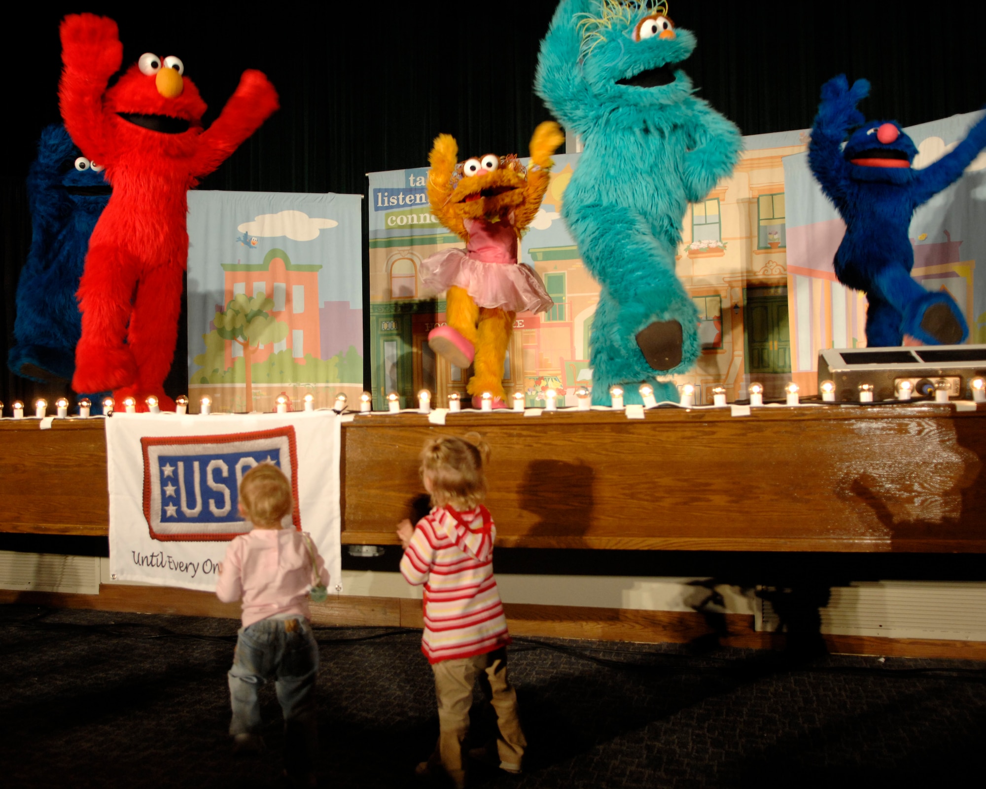 Cookie Monster, Elmo, Zoe, Rosita, and Grover sing and dance to several of their hits such as “Somebody Come and Play,” and the “Sesame Street” theme song during “The Sesame Street Experience for Military Families” USO Tour Oct. 16 and 17 at the base theater. Military families who attended the show received giveaways and outreach materials from Talk, Listen, Connect and other partners that sponsored this free event. (U.S. Air Force photo/Senior Airman Steven R. Doty)
