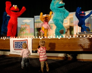Cookie Monster, Elmo, Zoe, Rosita, and Grover sing and dance to several of their hits such as “Somebody Come and Play,” and the “Sesame Street” theme song during “The Sesame Street Experience for Military Families” USO Tour Oct. 16 and 17 at the base theater. Military families who attended the show received giveaways and outreach materials from Talk, Listen, Connect and other partners that sponsored this free event. (U.S. Air Force photo/Senior Airman Steven R. Doty)