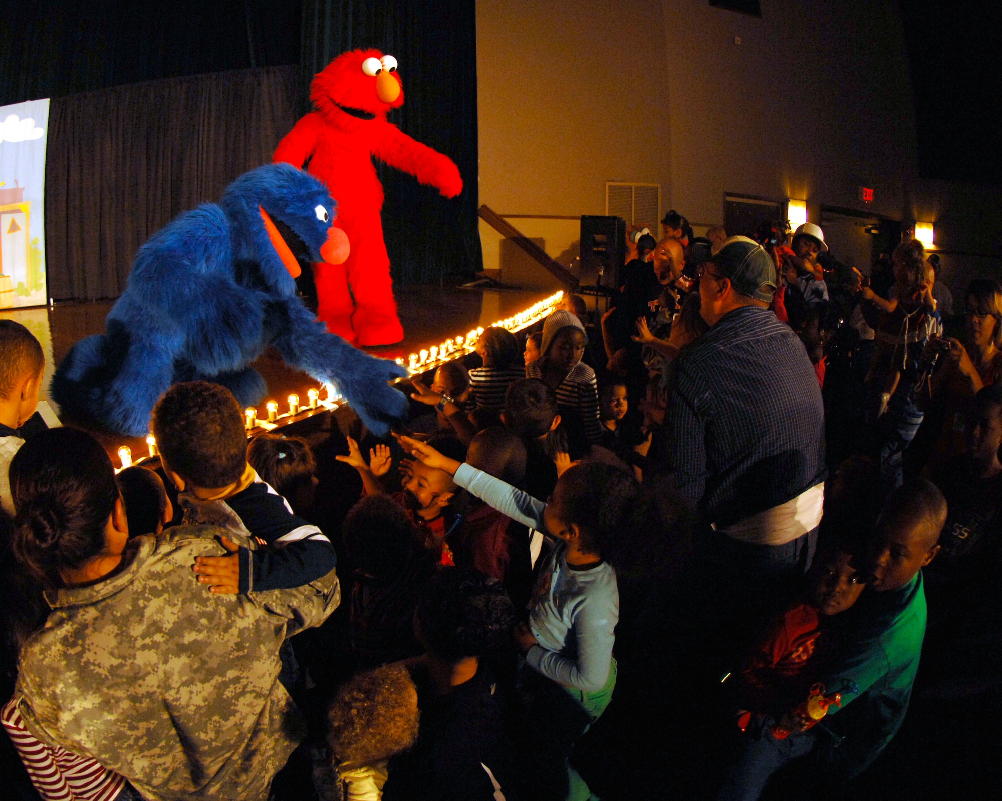 Grover and Elmo take time to meet children during “The Sesame Street Experience for Military Families” USO Tour Oct. 16 and 17 at the base theater. The show was designed to provide parents with new tools to help their children learn how to deal with the hardships of deployments and military life. (U.S. Air Force photo/Senior Airman Steven R. Doty)