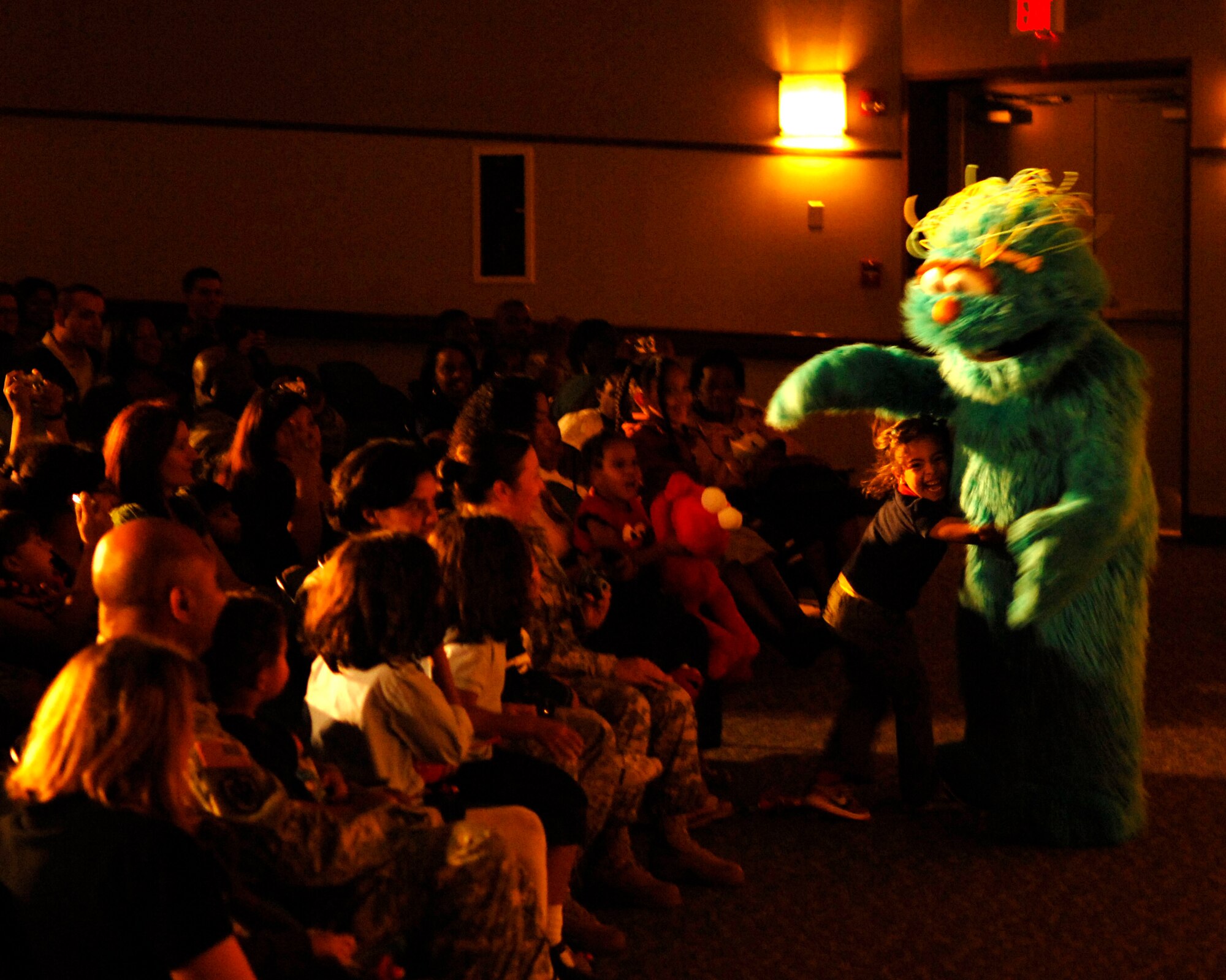 Rosita hugs one of her fans during “The Sesame Street Experience for Military Families” USO Tour Oct. 16 and 17 at the base theater.  Over 1,000 tickets were given to military families per show so children could meet some of their favorite muppets and better understand when a parent deploys. (U.S. Air Force photo/Senior Airman Steven R. Doty)