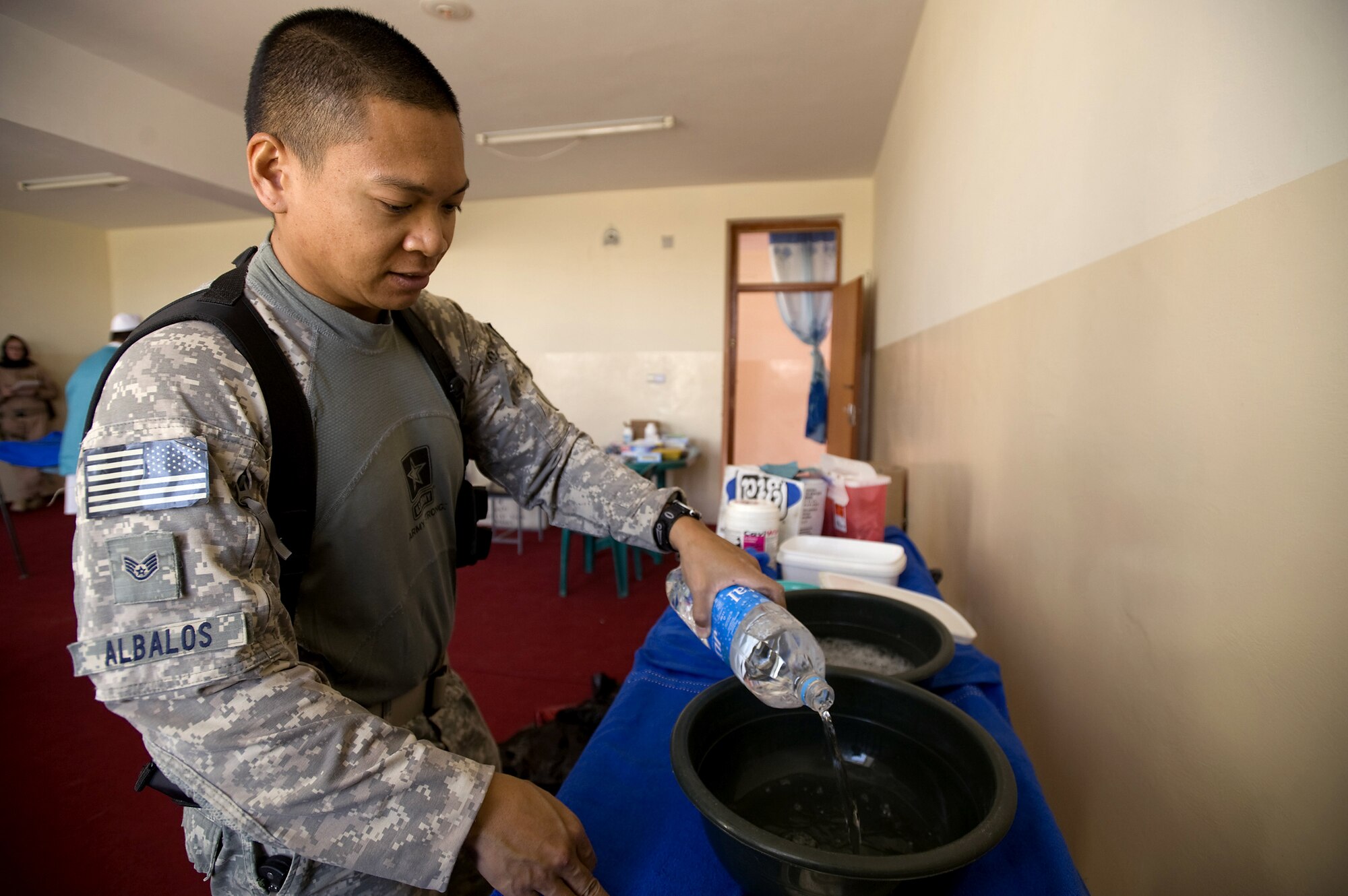 Staff Sgt. Nestor Albalos prepares an infection control station to clean dental tools prior to a village dental outreach visit Oct. 11 in Zabul, Afghanistan. The visit was hosted by the Zabul Provincial Reconstruction Team. Sergeant Albalos, a PRT combat medic, assisted in the removal of teeth and sanitized tools during the visit. Sergeant Albalos, a native of Stockton, Calif., is from Travis Air Force Base, Calif. (U.S. Air Force photo/Master Sgt. Keith Brown) 
