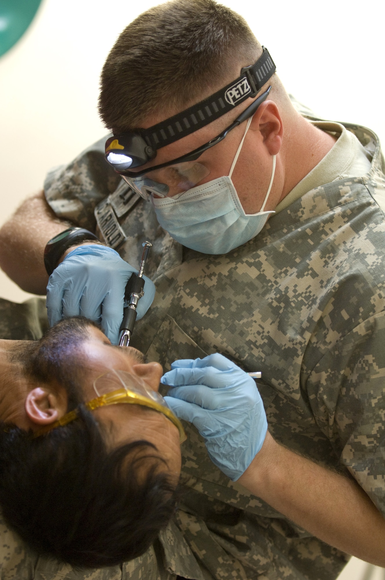 Capt. (Dr.) James Arnold injects an Afghan patient with novocain at a village dental outreach visit Oct. 11 in Zabul, Afghanistan. Captain Arnold is a Zabul Provincial Reconstruction Team members and a family practice doctor from Andersen Air Force Base, Guam.(U.S. Air Force photo/Master Sgt. Keith Brown) 

