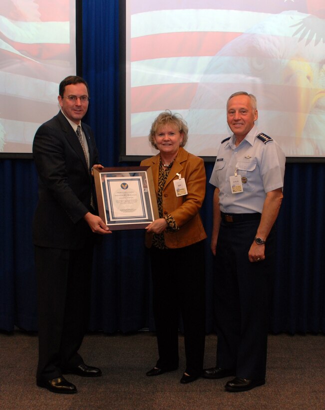 WRIGHT-PATTERSON AIR FORCE BASE, Ohio (AFMCNS) — Dr. Steve Butler pauses with Assistant Secretary of the Air Force for Acquisition Sue Payton and Gen. Bruce Carlson, commander of Air Force Materiel Command, after Ms. Payton presented Dr. Butler with a Probationary Silver Delegation for the Acquisition of Services certificate. The presentation, which took place here Oct. 21, follows an August agreement between AFMC and the Air Force Program Executive Office for Combat and Mission Support, commonly called PEO Services. The agreement established Dr. Butler, AFMC’s Executive Director, as the command’s Services Advocate and delegated management and oversight authority of services contracts between $100 million and $500 million to AFMC. The command stood up a multi-functional services team to support Dr. Butler. The team is collaborating with PEO Services to streamline the critical processes necessary to execute the authority. Team members will visit AFMC’s air logistics centers in November to deploy initial procedures. The team will host a services workshop in December for the requirements and acquisition community. (Air Force photo by Diana Leonard)