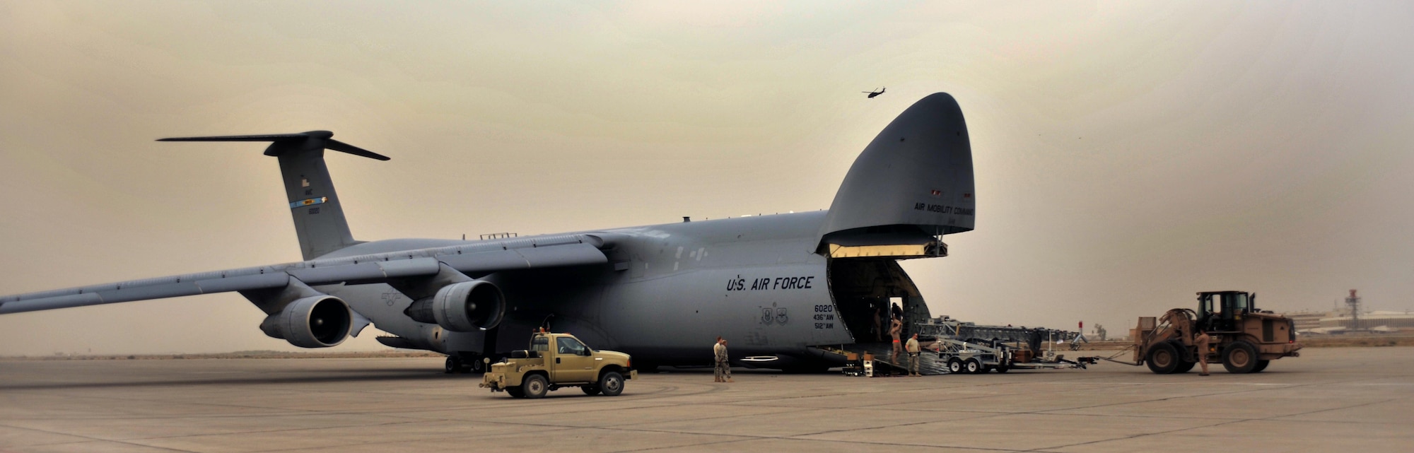 10/21/2008 ? SATHER AIR BASE, Iraq ? Airmen from the 447th Expeditionary Logistics Readiness Squadron at Sather Air Base work with the crew of a C-5 Galaxy cargo aircraft to off-load a special security tower. The tower is one of six units, each costing $1.6 million, designed to enhance force protection on and around the Victory Base Complex in Baghdad.  The units were delivered by the 9th Airlift Squadron from Dover Air Force Base, Del. (U.S. Air Force photo by Master Sgt. Brian Davidson)