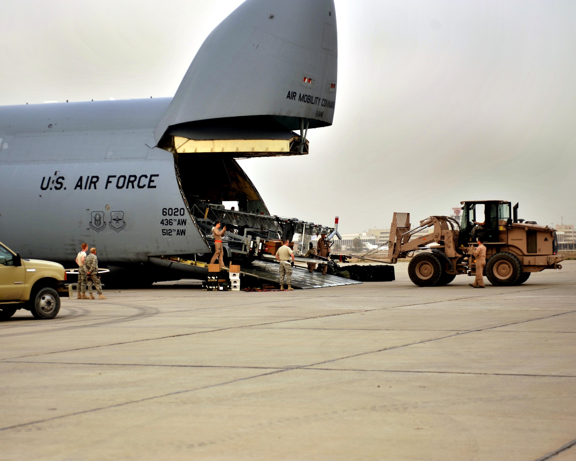 10/21/2008 ? SATHER AIR BASE, Iraq ? Airmen from the 447th Expeditionary Logistics Readiness Squadron at Sather Air Base work with the crew of a C-5 Galaxy cargo aircraft to off-load a special security tower. The tower is one of six units, each costing $1.6 million, designed to enhance force protection on and around the Victory Base Complex in Baghdad.  The units were delivered by the 9th Airlift Squadron from Dover Air Force Base, Del. (U.S. Air Force photo by Master Sgt. Brian Davidson)