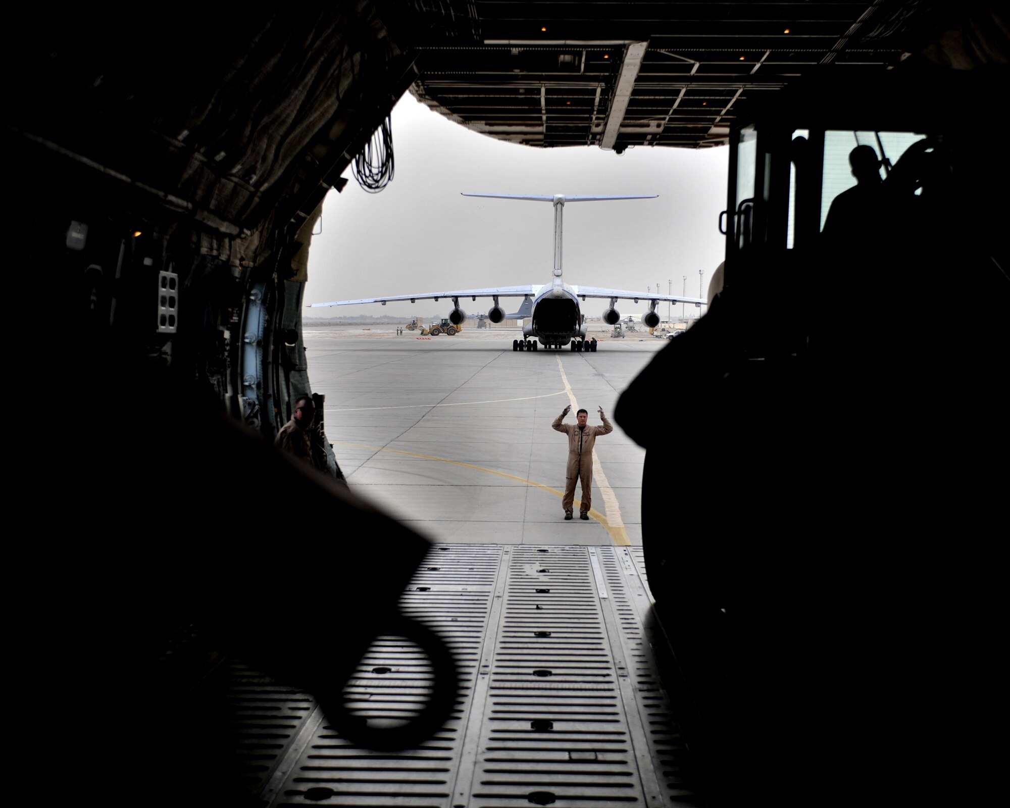 10/21/2008 ? SATHER AIR BASE, Iraq ? Tech. Sgt. Kevin Birch, C-5 Galaxy load master, directs the off-loading of a special security tower at Sather Air Base.  The tower is one of six units, each costing $1.6 million, designed to enhance force protection on and around the Victory Base Complex in Baghdad.  The units were delivered by the 9th Airlift Squadron from Dover Air Force Base, Del. (U.S. Air Force photo by Master Sgt. Brian Davidson)