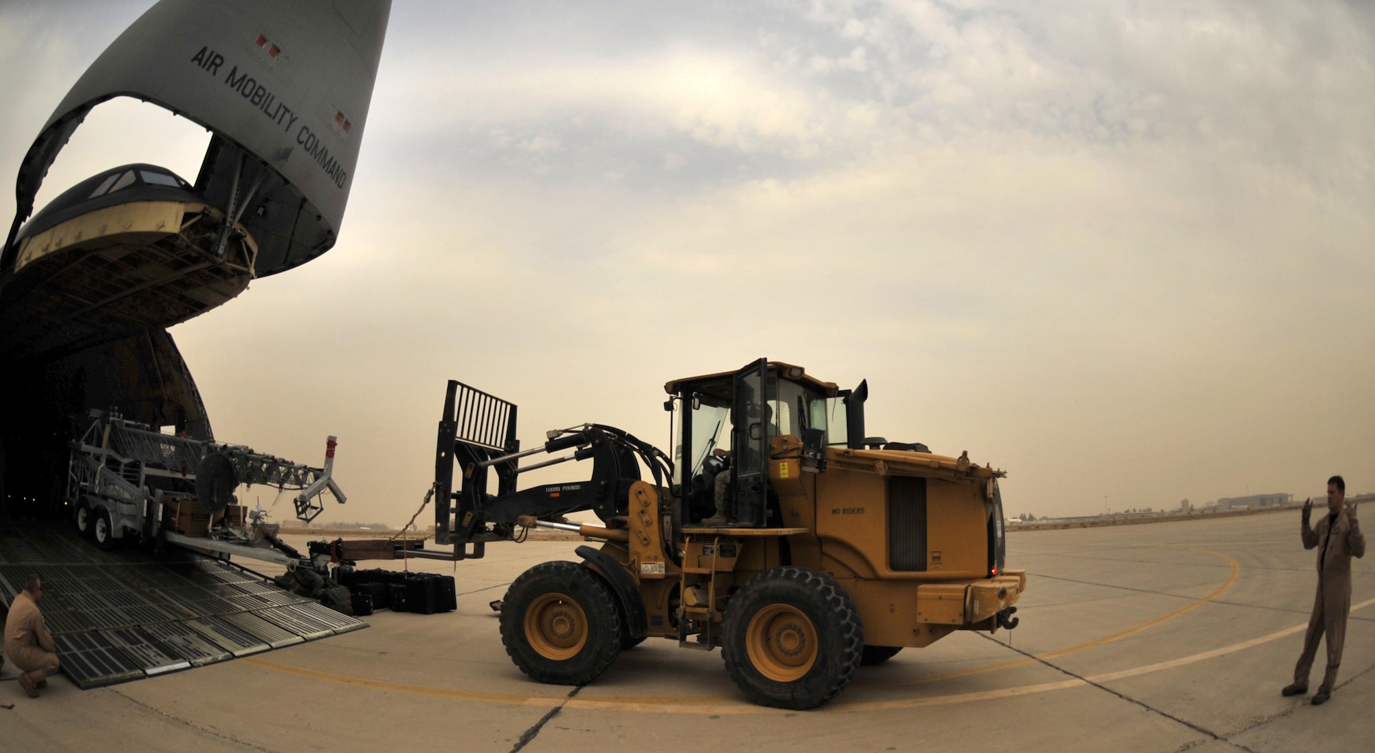 10/21/2008 ? SATHER AIR BASE, Iraq ? Tech. Sgt. Kevin Birch, C-5 Galaxy load master, directs the off-loading of a special security tower at Sather Air Base.  The tower is one of six units, each costing $1.6 million, designed to enhance force protection on and around the Victory Base Complex in Baghdad.  The units were delivered by the 9th Airlift Squadron from Dover Air Force Base, Del. (U.S. Air Force photo by Master Sgt. Brian Davidson)