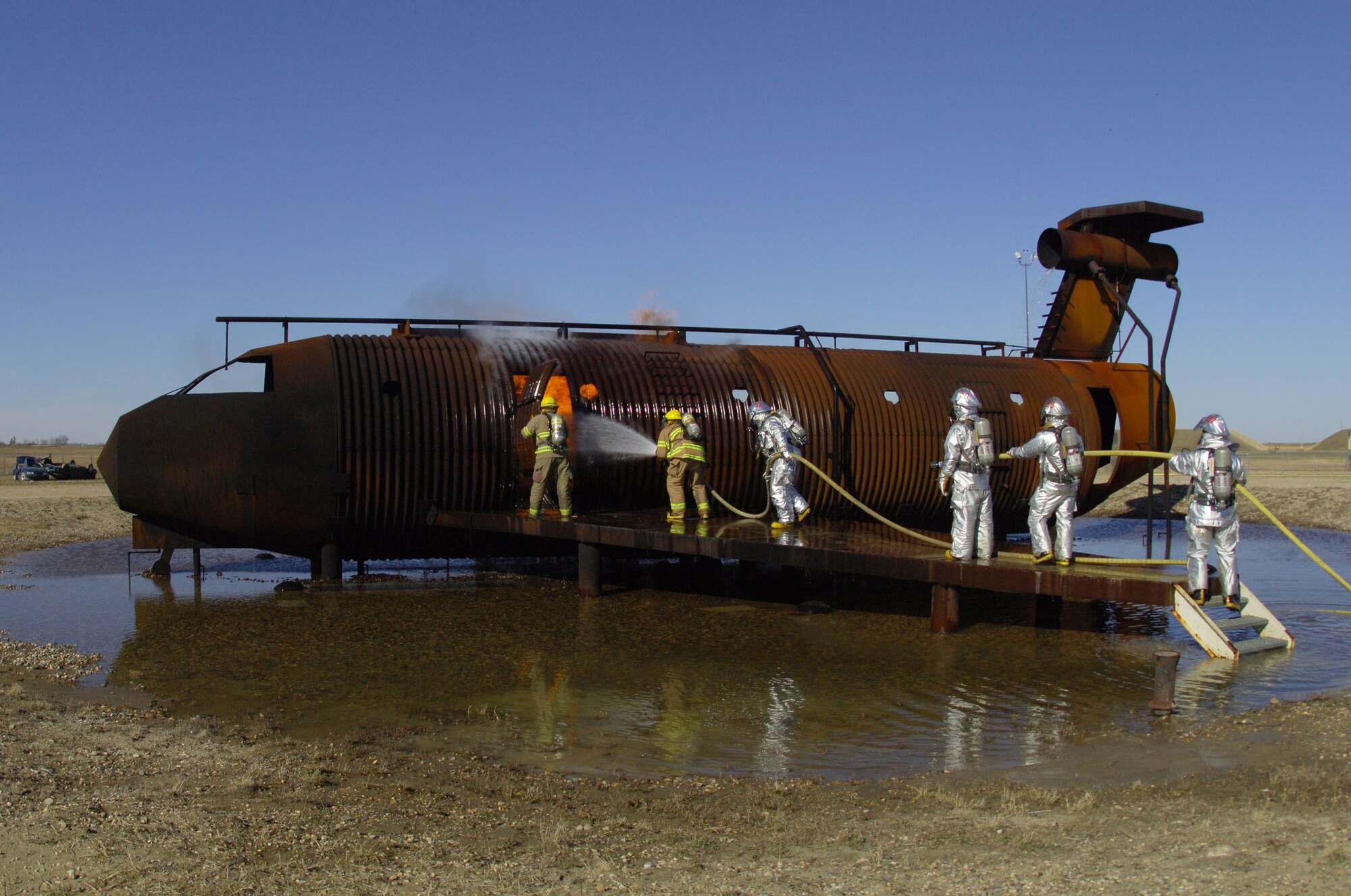 MINOT AIR FORCE BASE, N.D. – Firefighters from the city of Minot, N.D., take the lead during an aircraft-fire training scenario here Oct. 20. The scenario was part of a joint training exercise where firefighters from both Minot and Minot AFB participated in several scenarios to enhance mission effectiveness. (US Air Force photo by Senior Airman Cassandra Jones)