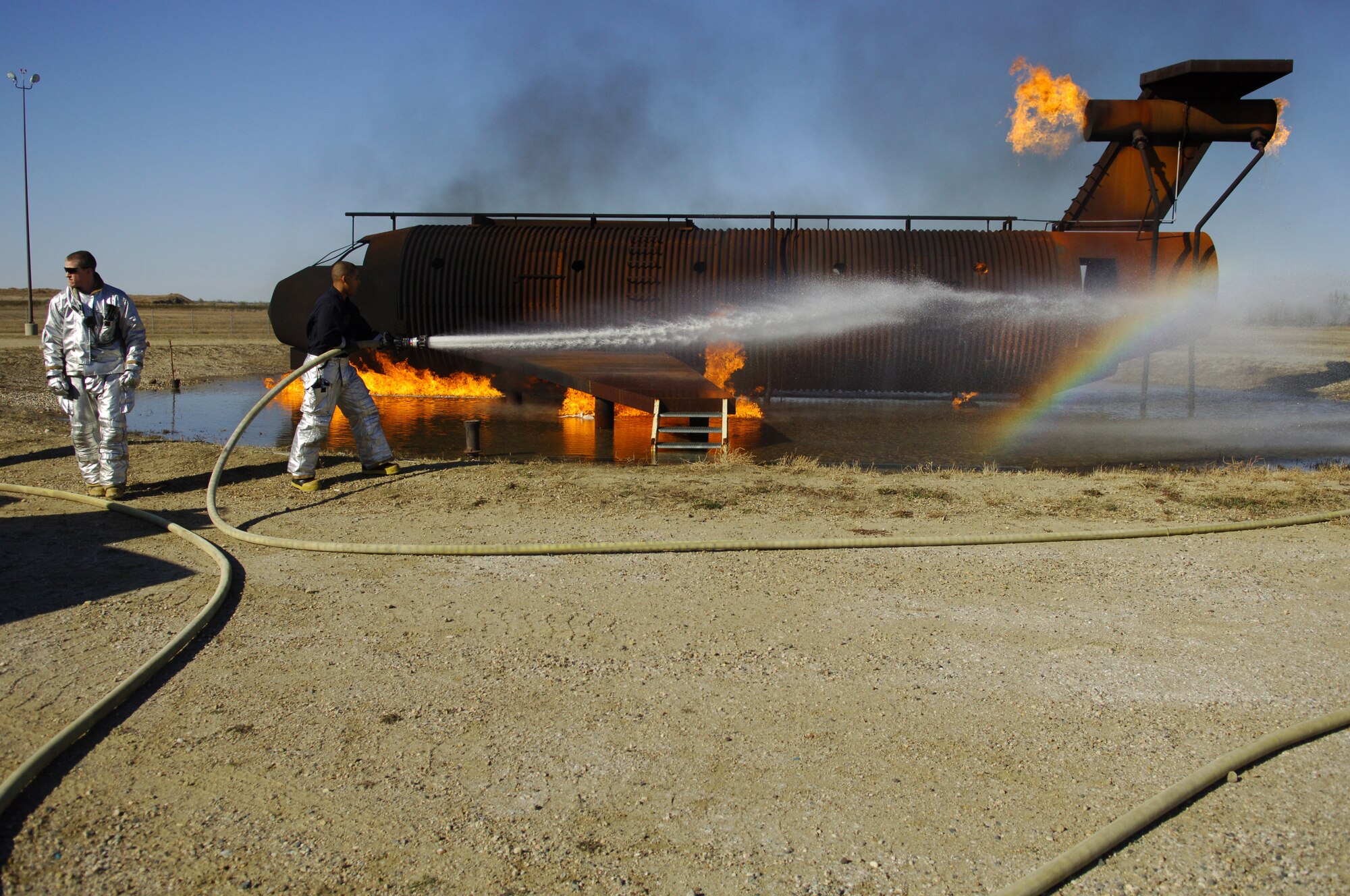 MINOT AIR FORCE BASE, N.D. – Airman 1st Class Eric Kautz, 5th Civil Engineer Squadron firefighter, prepares the fire hose during an aircraft-fire training scenario here Oct. 20. The scenario was part of a joint training exercise where firefighters from both the city of Minot, N.D., and Minot AFB participated in several scenarios to enhance mission effectiveness. (US Air Force photo by Senior Airman Cassandra Jones)