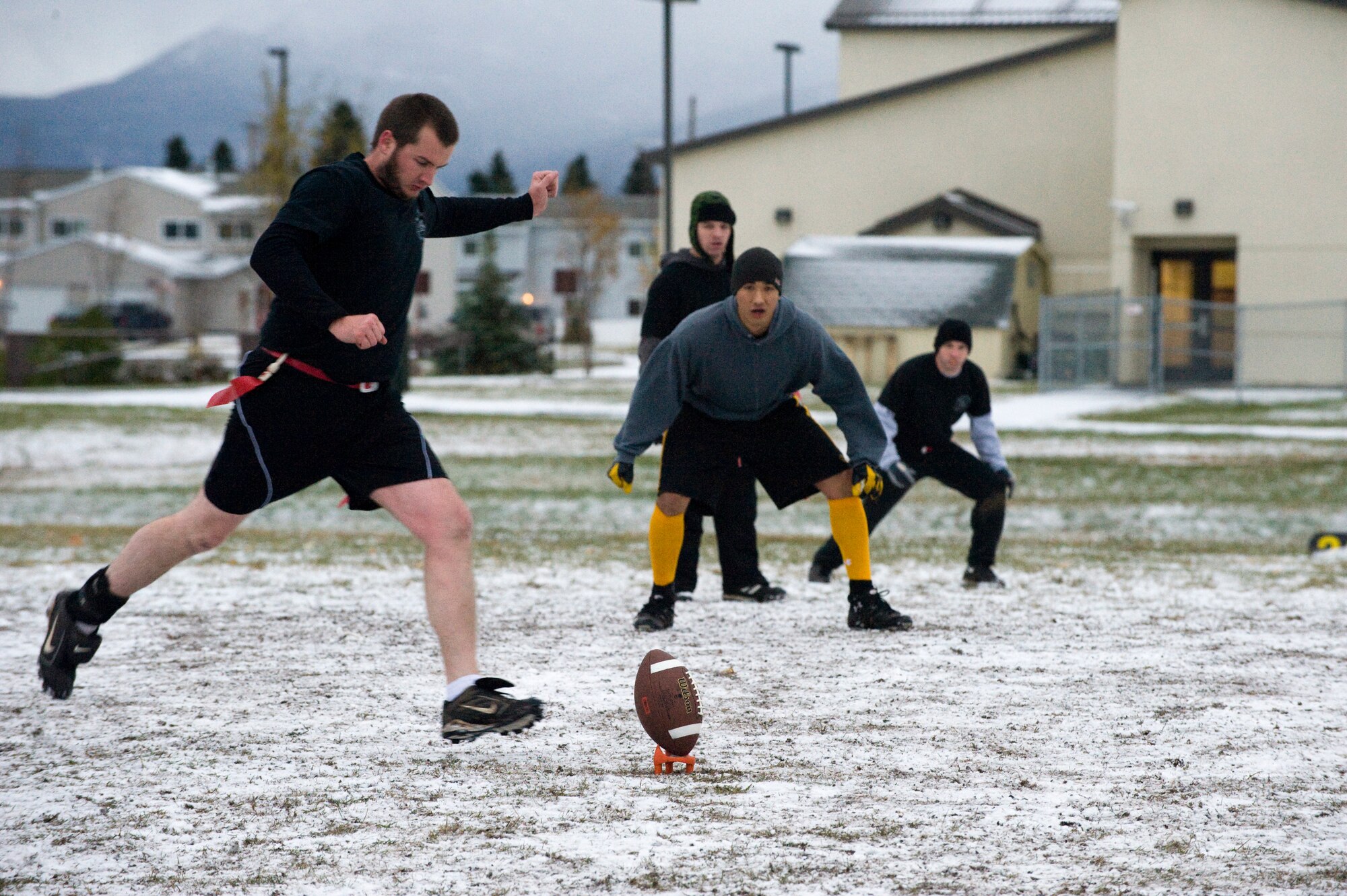 ELMENDORF AIR FORCE BASE Alaska -- Adam Crow, husband of Senior Airman Lauren Crow, 381st Intelligence Squadron, kicks off during the intramural flag football championship game here Oct. 9. Adam Crow and fellow players from the 381st IS were undefeated prior to entering the championship game. The 381st lost to the 962nd 12-15. (U.S. Air Force photo/Staff Sgt. Joshua Garcia)