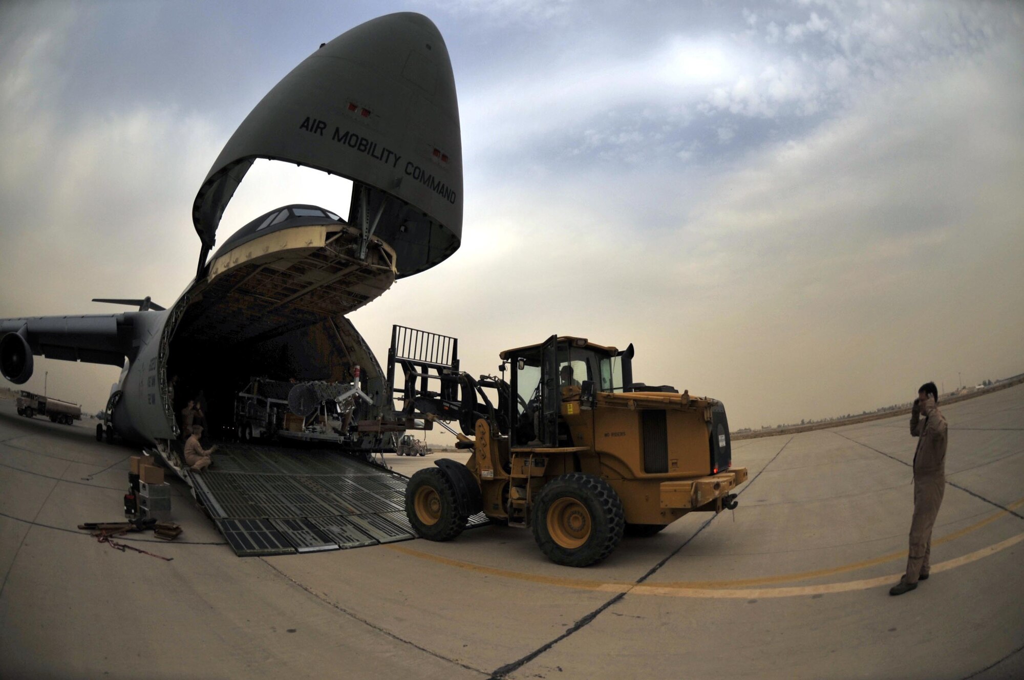 10/21/2008 ? SATHER AIR BASE, Iraq ? Tech. Sgt. Kevin Birch, C-5 Galaxy load master, directs the off-loading of a special security tower at Sather Air Base.  The tower is one of six units, each costing $1.6 million, designed to enhance force protection on and around the Victory Base Complex in Baghdad.  The units were delivered by the 9th Airlift Squadron from Dover Air Force Base, Del. (U.S. Air Force photo by Master Sgt. Brian Davidson)