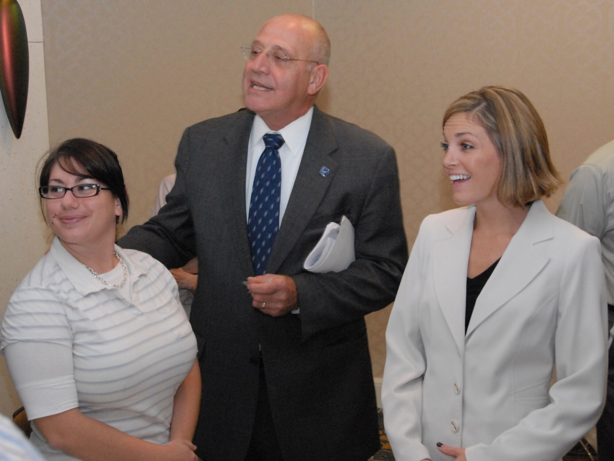 HANSCOM AIR FORCE BASE, Mass. -- Blaise Durante, the Air Force deputy assistant secretary for Acquisition Integration, visits with Electronic Systems Center acquisition program management trainees Elisa Esterley (left) and Christin Gurgo Oct. 16.  Mr. Durante addressed government and industry members at a luncheon sponsored by the Lexington-Concord Chapter of the Armed Forces Communications and Electronics Association at the Doubletree Bedford Glen Hotel, near Hanscom. (U.S. Air Force Photo by J.C. Corcoran) 