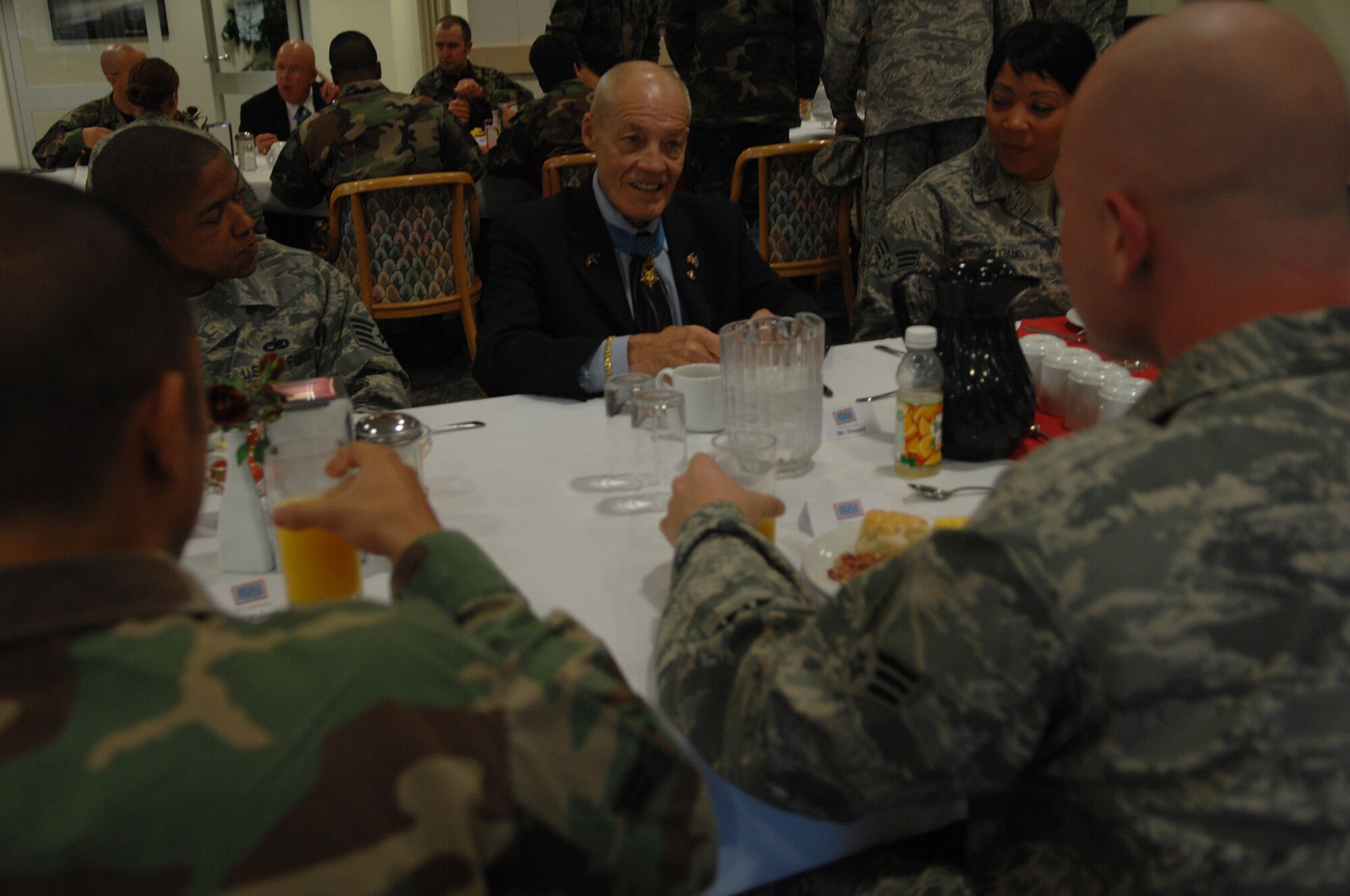 Bob Howard, U.S. Army Col. (Ret.), Congressional Medal of Honor recipient, talks with Ramstein Airmen of  various ranks during a breakfast at the Rhineland Inn Dining Facility, Ramstein Air Base, Germany, Oct. 21, 2008. Col. Howard, who was awarded the Medal of Honor for heroic acts during the Vietnam War, visited the dining facility during a morale tour sponsored by the USO. (U.S. Air Force photo by Airman 1st Class Tony)