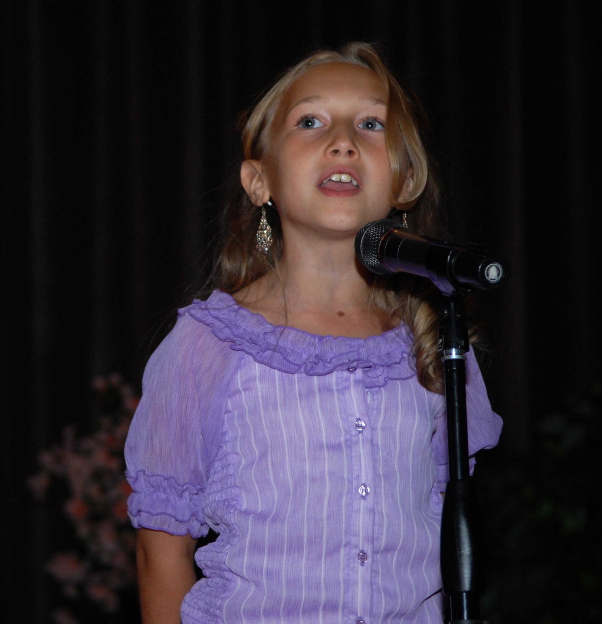 VANDENBERG AIR FORCE BASE, Calif.-- Keirsten Wahlie sings the Star Spangled Banner at the Family and Teen talent show search held at the base theater. (U.S. photo by Airman 1st Class Antoinette Lyons)