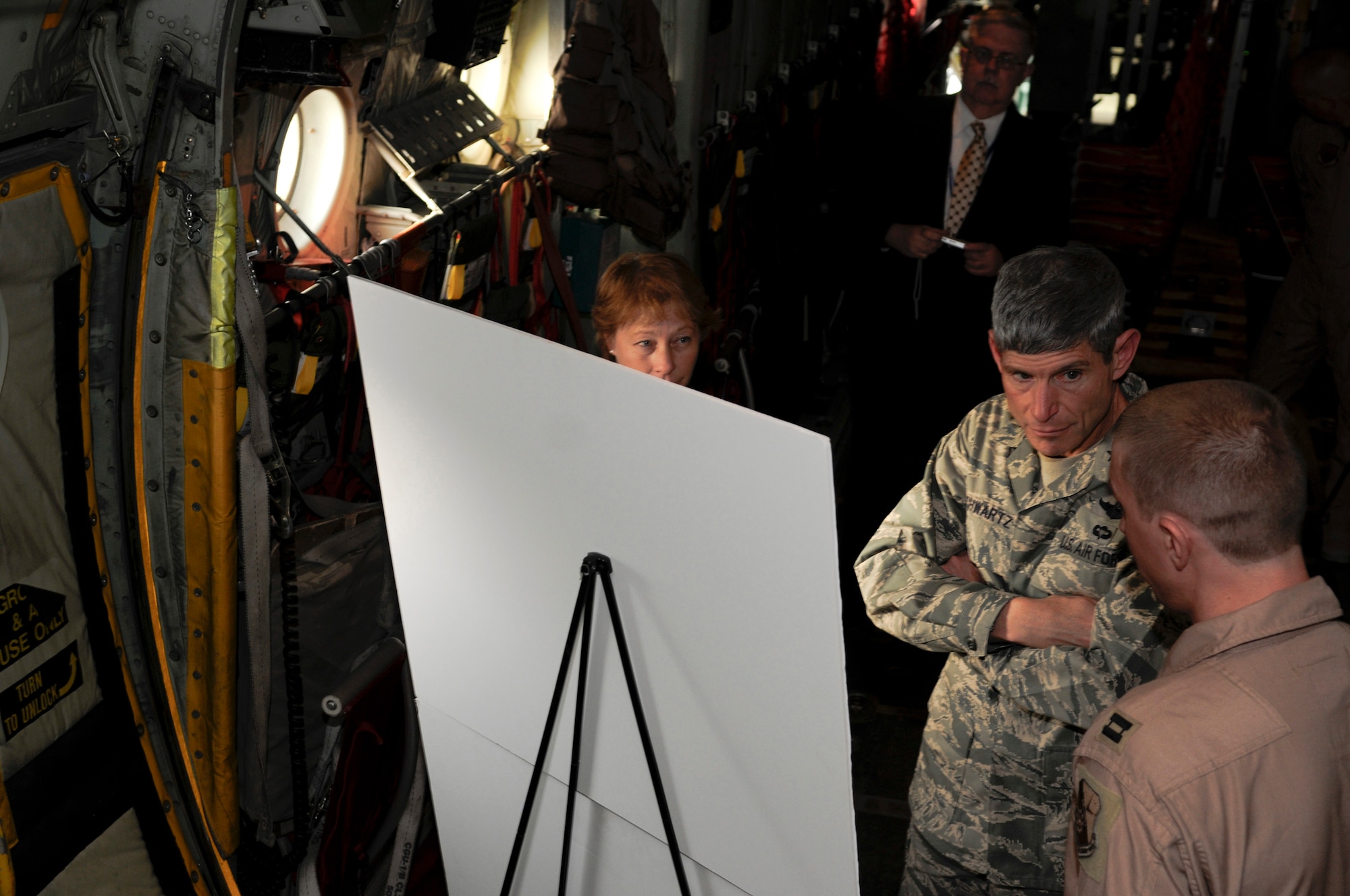 Lt. Col. Georgeanne Johnson and Capt. Stephen Boskovich brief Air Force Chief of Staff Gen. Norton Schwartz on their squadron's mission and contribution to the war on terrorism Oct. 20. The 379th Air Expeditionary Wing is General Schwartz's first stop on his first tour of the U.S. Air Forces Central area of responsibility since his appointment as the Air Force chief of staff. Colonel Johnson and Captain Boskovich are both assigned to the 379th Expeditionary Aeromedical Evacuation Squadron. (U.S. Air Force photo/Tech. Sgt. Michael Boquette)