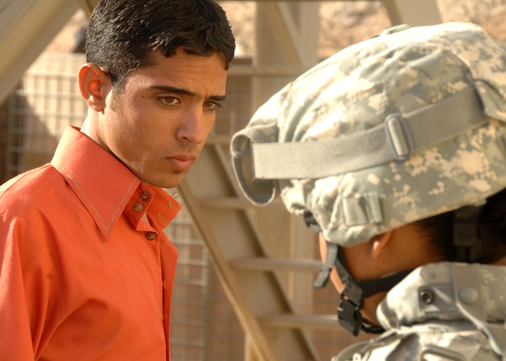 An Iraqi man waits for permission to proceed through a security checkpoint manned by Senior Airman Naomi Espinoza Oct. 4 at Camp Bucca, Iraq. The 586th AEG provides security for the camp's visitation center, where nearly 400 visitors are allowed to visit daily with detainees being held at the theater internment facility. Airman Espinoza is assigned to the 586th Air Expeditionary Group. (U.S. Air Force photo)