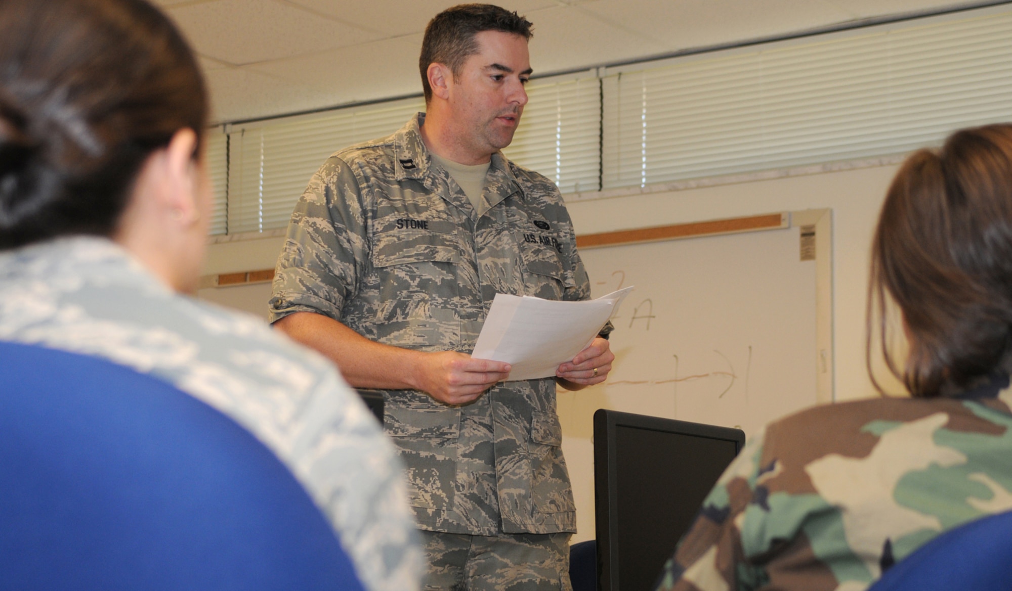 Captain Stone introduces a team-building exercise to 2nd Lts. Amanda Pelkowski, left, and Crystal Vogt, students in the new course.  Lieutenant Pelkowski is stationed at Patrick Air Force Base, Fla., and Lieutenant Vogt is assigned to Pope AFB, N.C.