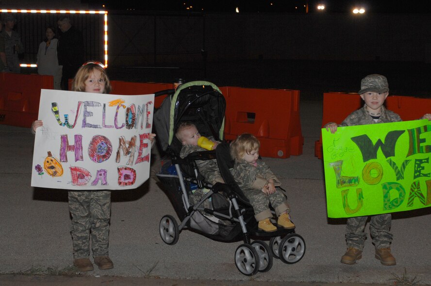 DYESS AIR FORCE BASE, Texas -- Senior Airman Matthew Swangin's family waits for him during his briefing session after his return home from deployment here, Oct. 20. Airman Swangin, from the 317th Aircraft Maintenance Squadron, was part of 100+ Airman that returned after a four month deployment from Southwest Asia today. (U.S. Air Force photo/Senior Airman Jennifer Romig)